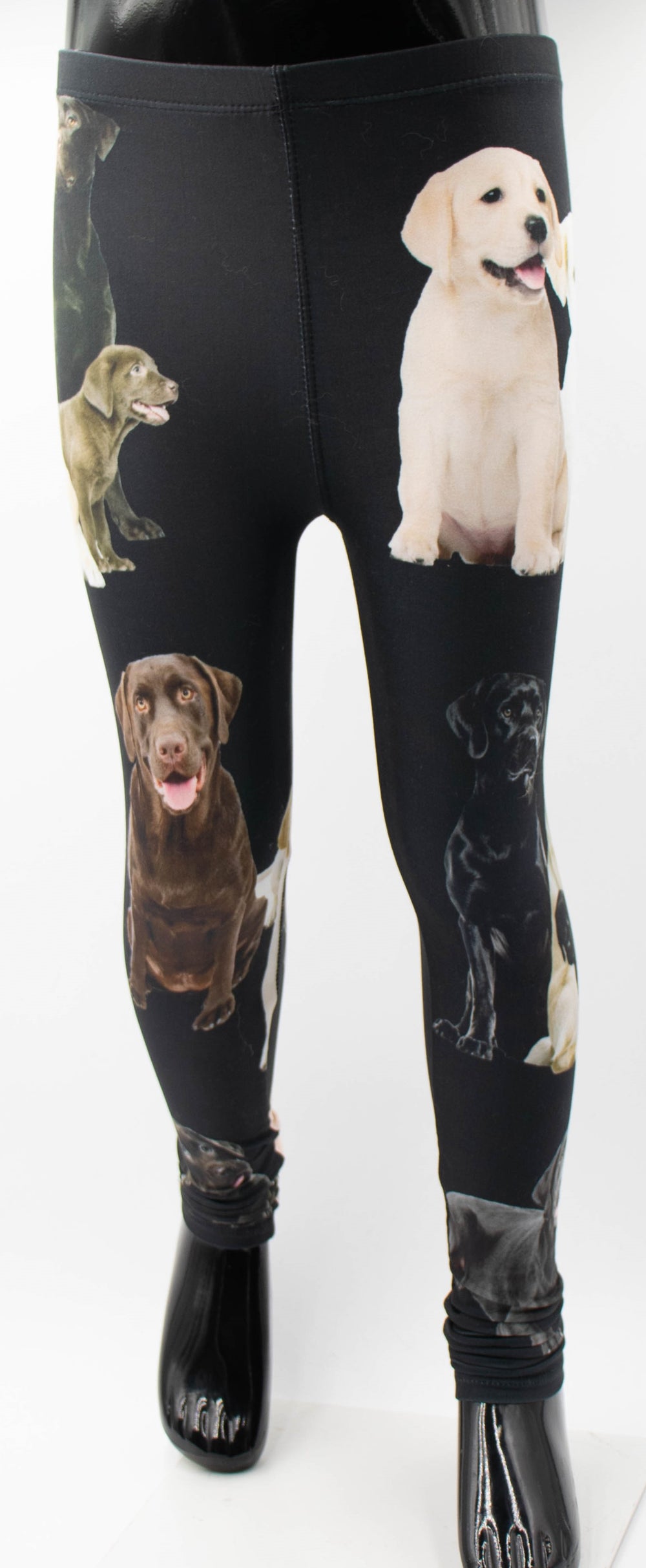 Close-up of Denimaxx kids black Labrador print leggings showing yellow, chocolate, and black Labrador artwork on the legs.