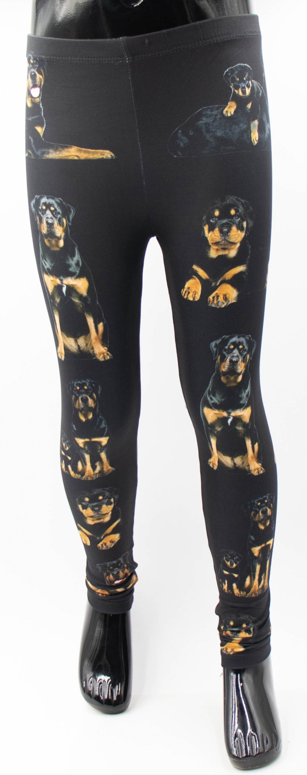 Denimaxx kids Rottweiler print leggings with realistic black and tan rottweiler portraits on black fabric, front view on a mannequin.