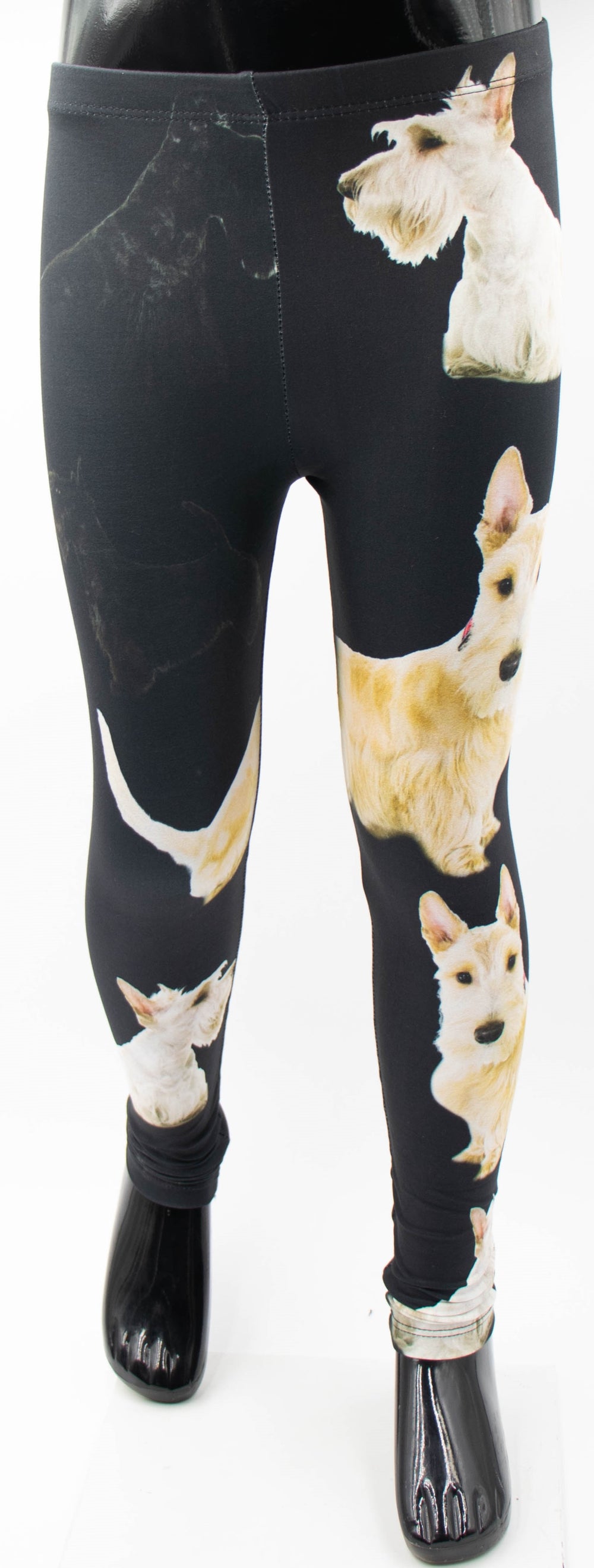 Front view of Denimaxx kids black leggings with cream Scottish Terrier dog prints, shown on a mannequin.