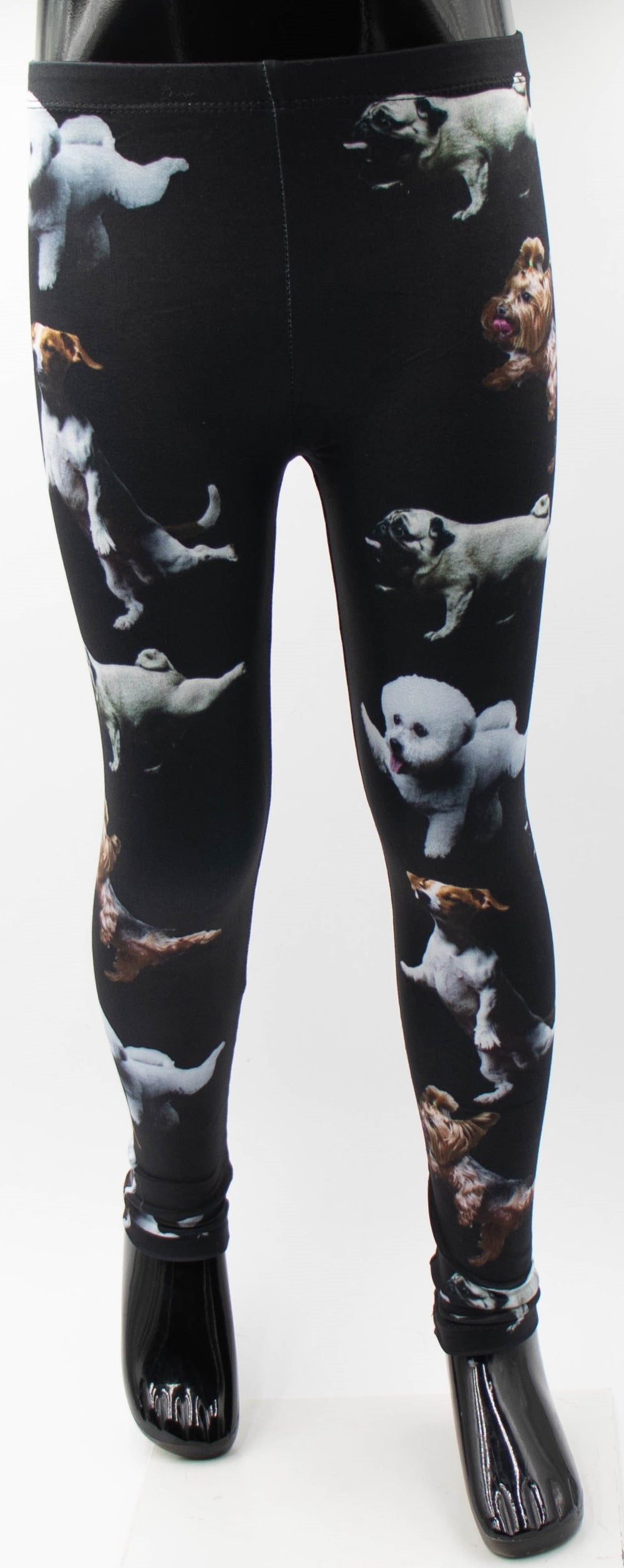 Denimaxx kids playful dog print leggings with jumping Pugs, Yorkies, and white pups on black fabric, shown on a mannequin.