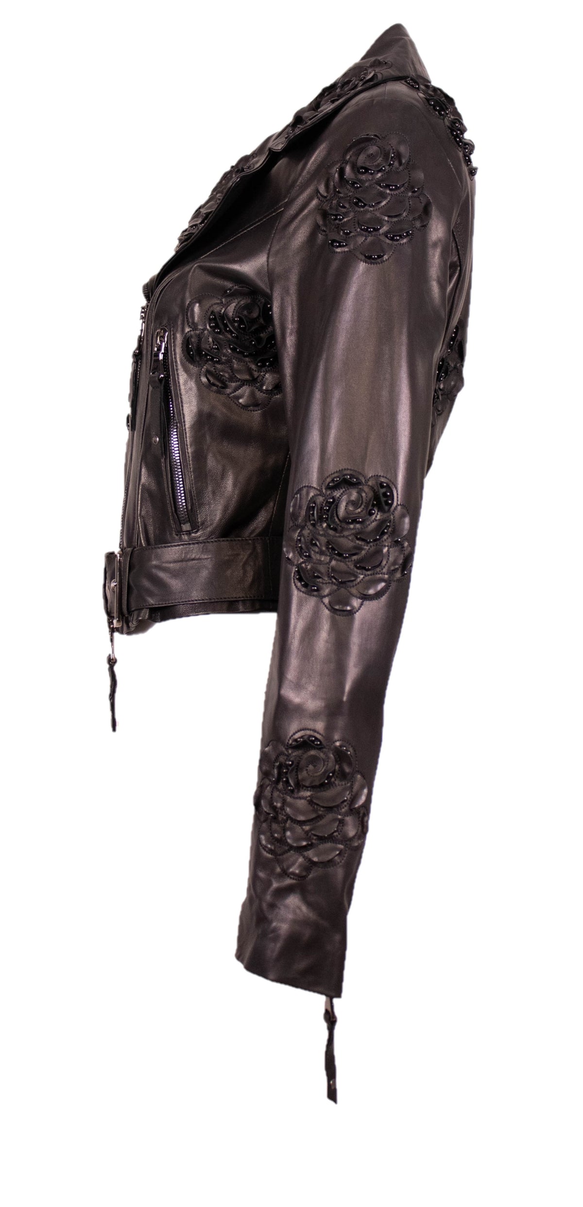 Side view of the black leather jacket with embroidered black roses running down the sleeve, zip pockets, on white.