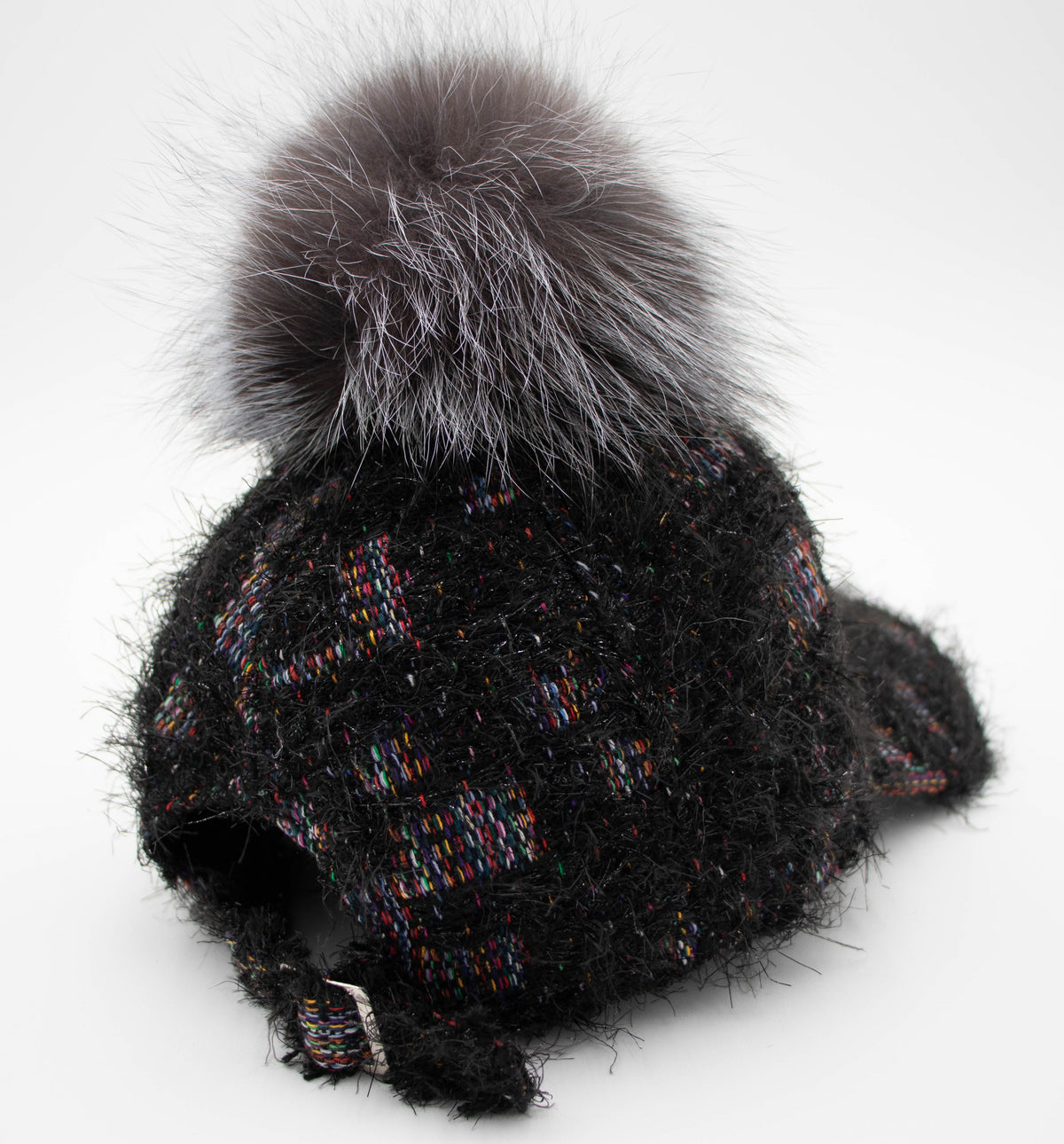 Back angle of the black fuzzy knit Vail cap with gray fur pom and adjustable back strap.