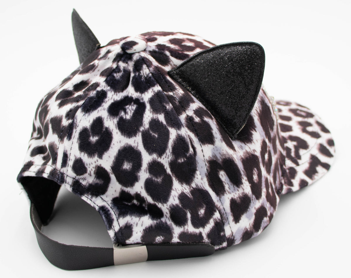 Back angle of the Crystal Vail cat ear cap showing leopard print, black cat ears, and the adjustable back strap.