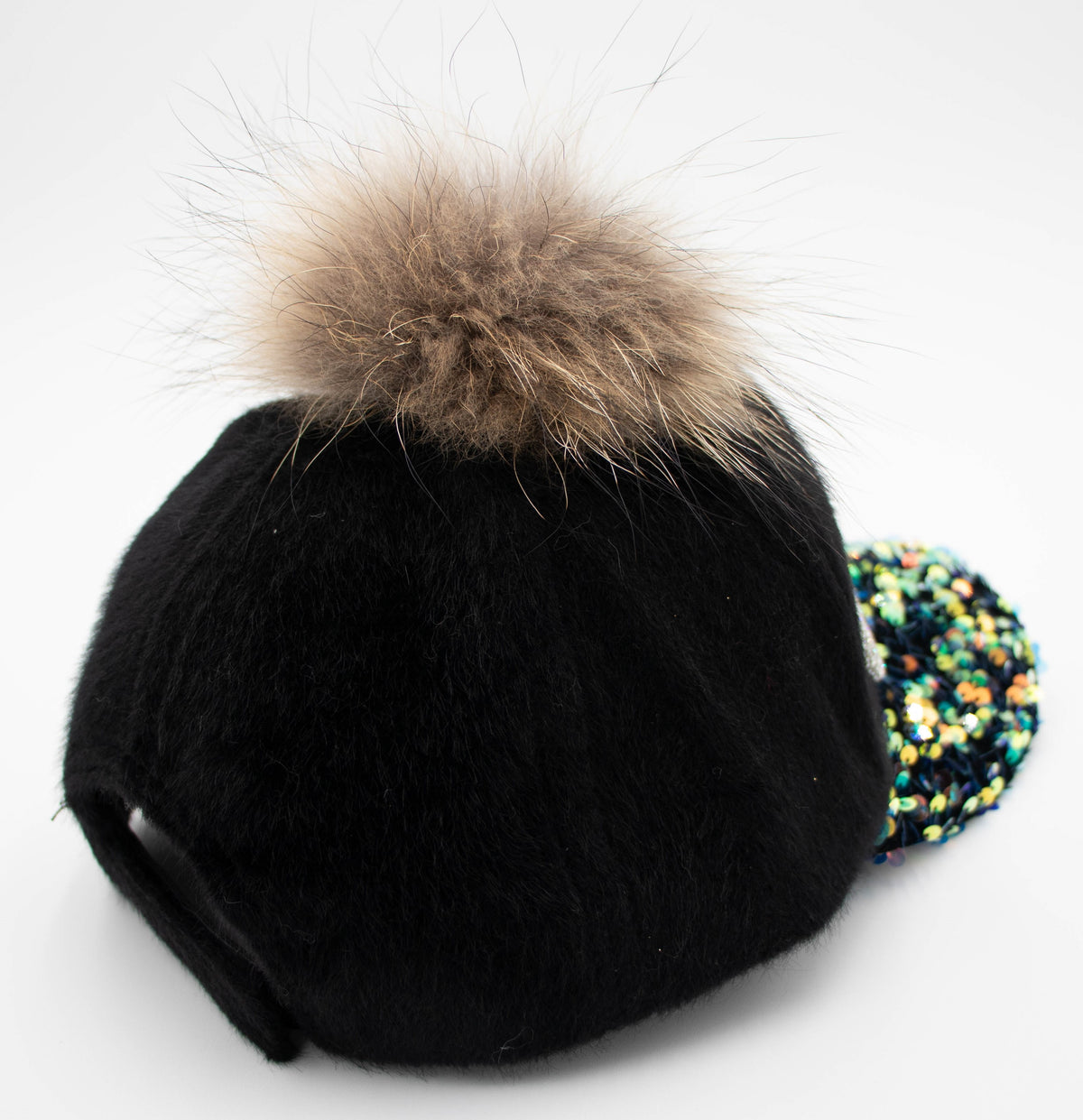 Back view of the Vail crystal-embellished black cap with its fluffy faux fur pom and sequin-trimmed brim edge.