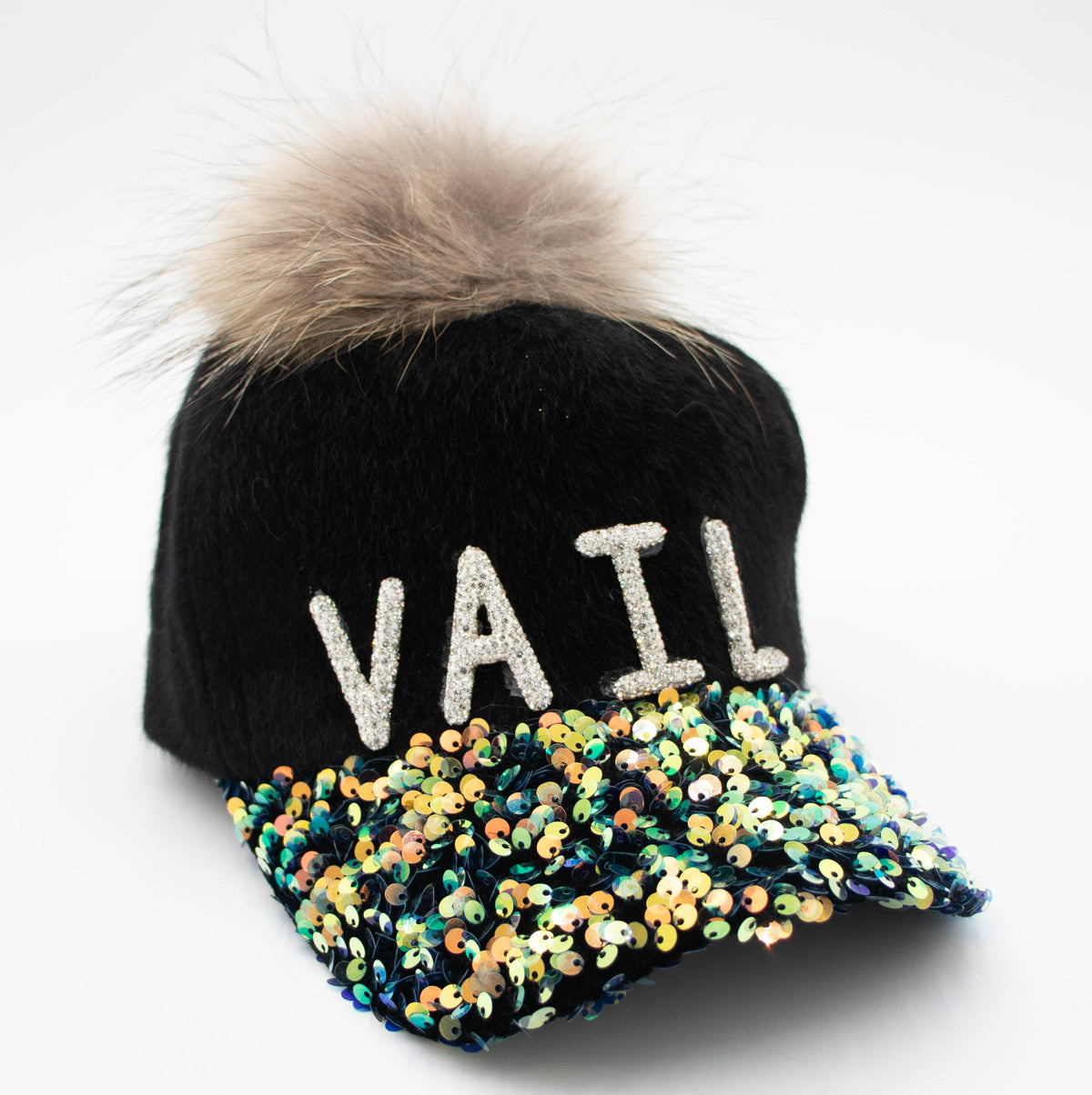 Vail crystal-embellished black baseball cap with sparkling VAIL lettering, colorful sequin brim, and faux fur pom.