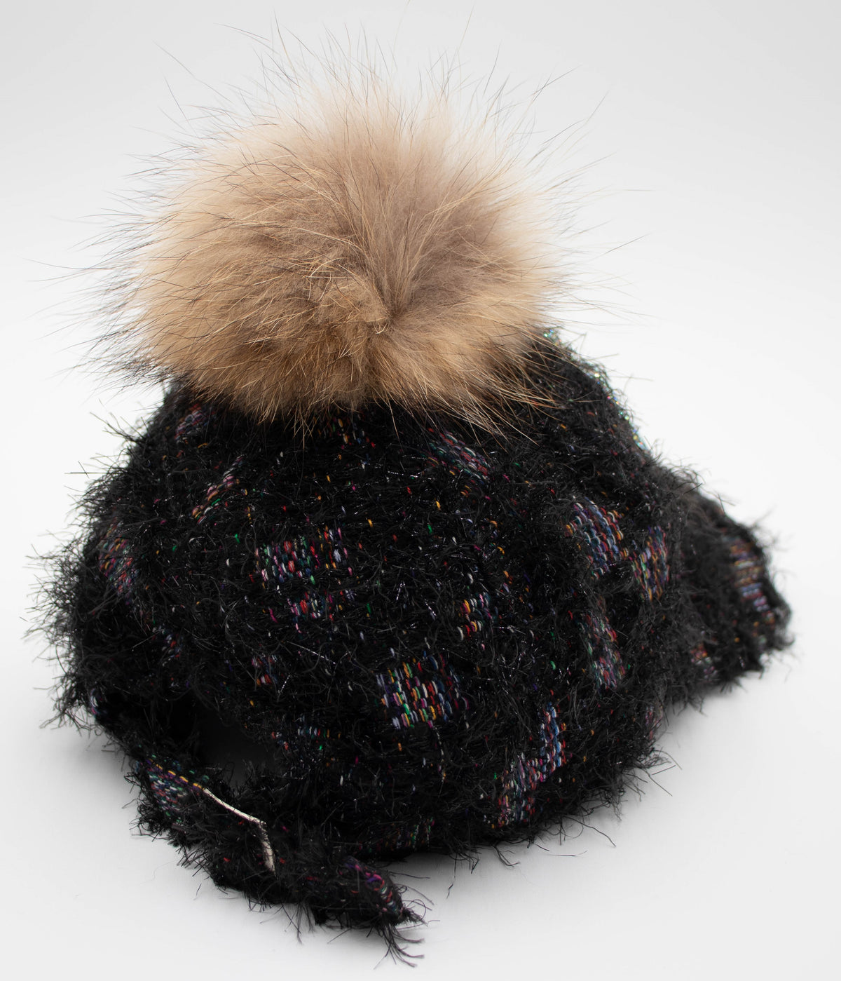Side view of the Crystal Park City baseball cap with black fuzzy tweed, multicolor threads, and a tan faux fur pom.