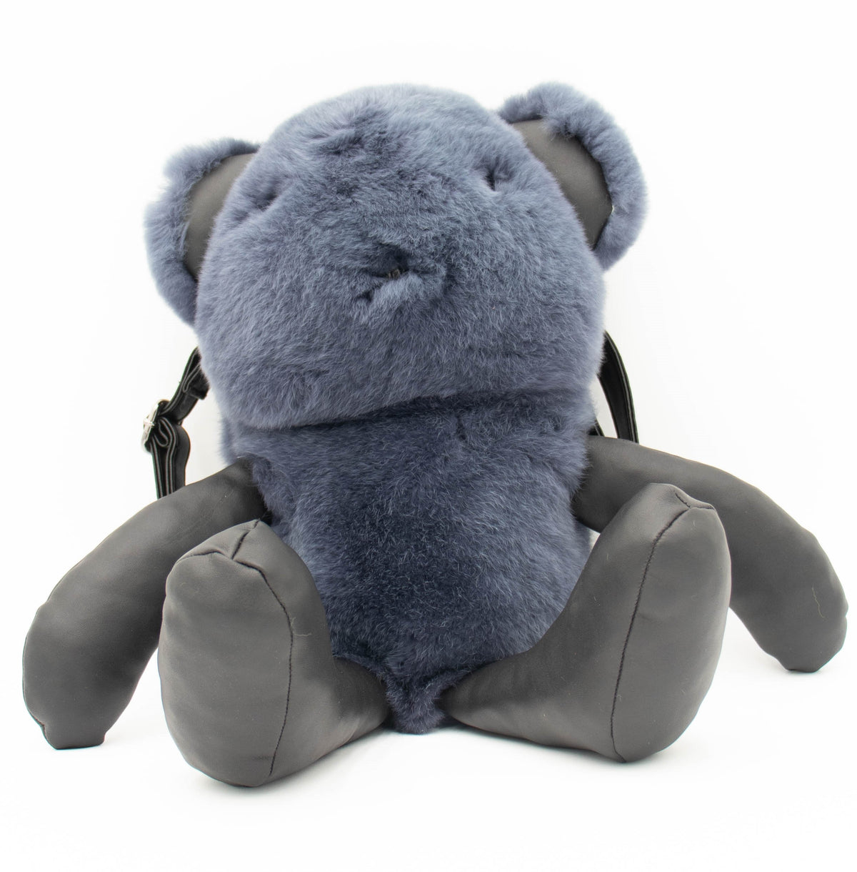 Front view of the blue rex rabbit fur bear-shaped backpack with gray leather arms and legs, studio shot on white.