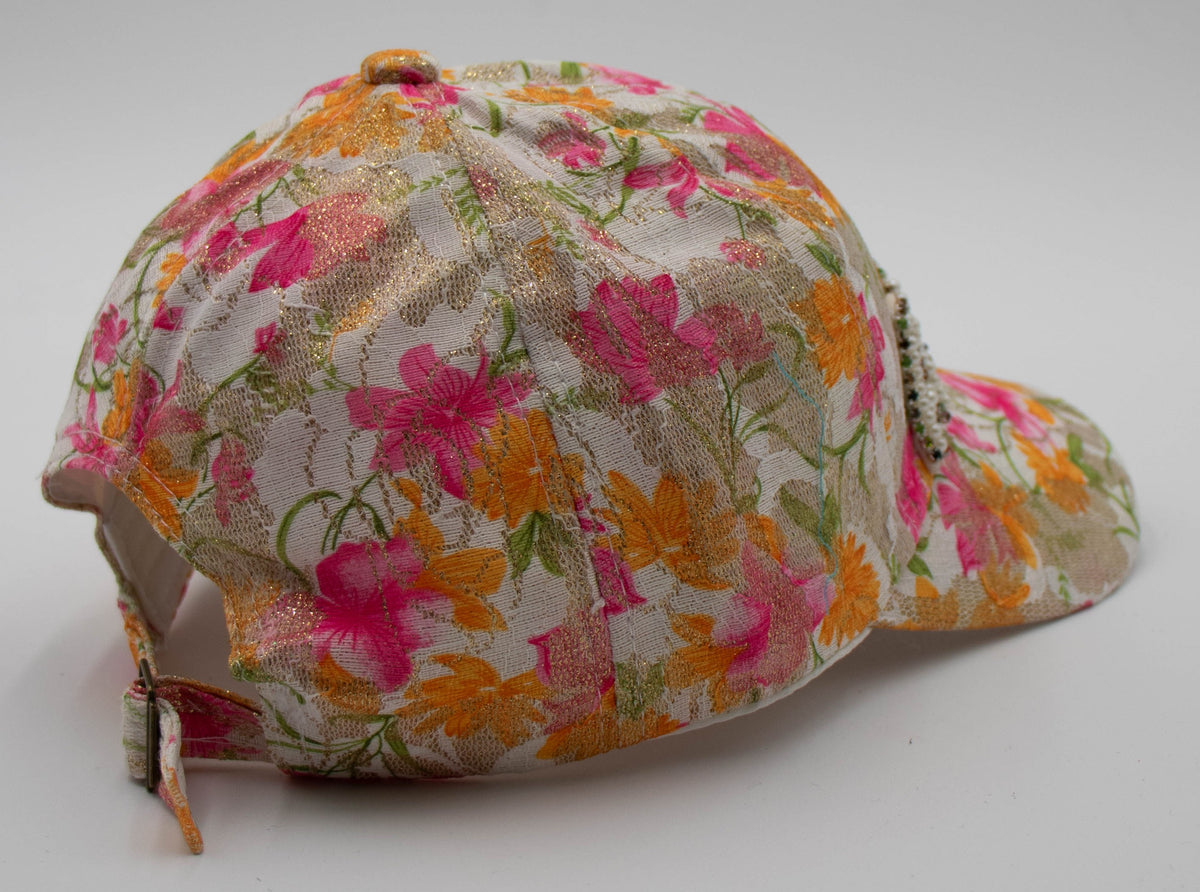Side view of the Pearl-Detail Aspen baseball cap showing the floral lace crown and adjustable back strap on a white background.