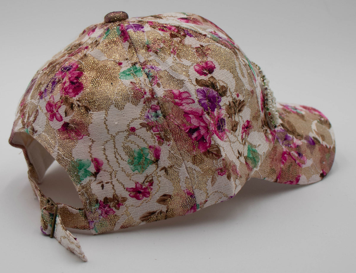 Back angle of the Pearl Aspen pearlescent baseball cap showing the gold floral brocade and adjustable back strap.