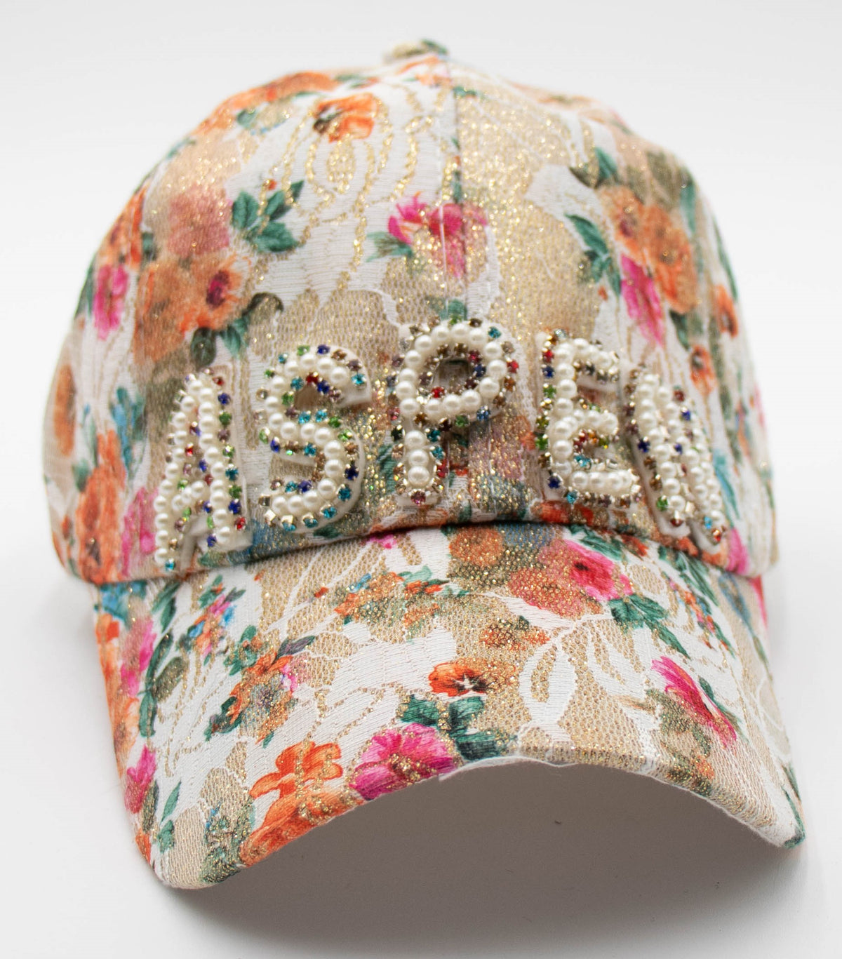 Pearl Aspen floral baseball cap with orange and pink flowers and pearl-beaded ASPEN lettering, front view.