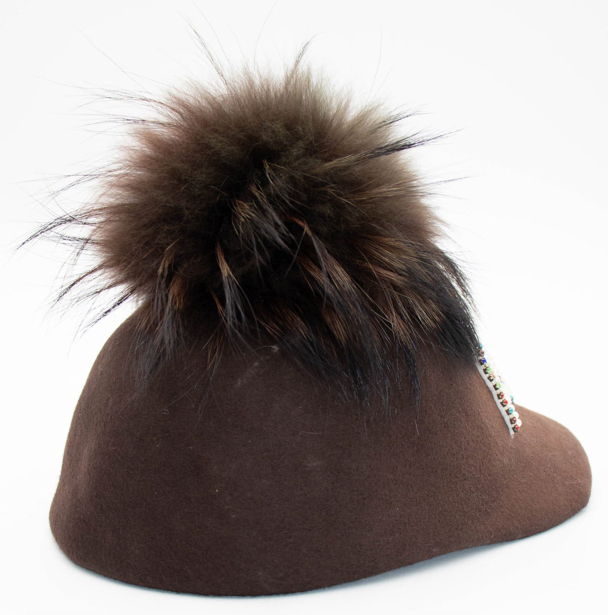 Back view of the Aspen Pearl brown cap showing the dark faux fur pom, product shot on white.