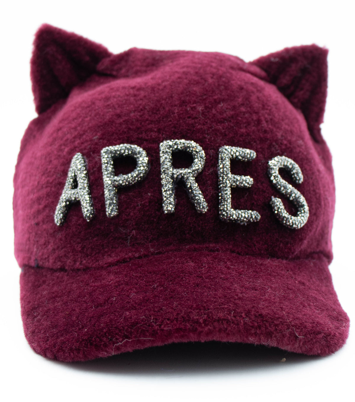 Burgundy faux fur cat ear cap with silver crystal APRES lettering, front view on a white background.