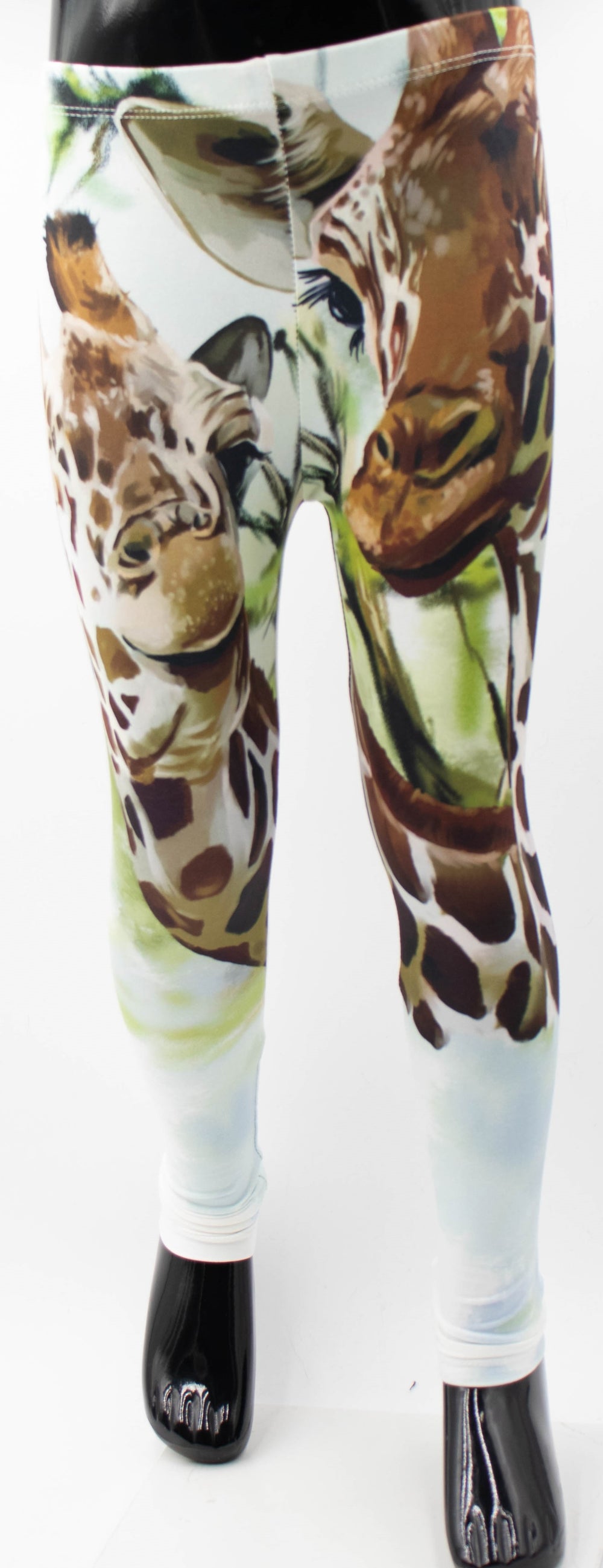 Denimaxx kids giraffe print leggings with large painted giraffe faces on white fabric, front view on mannequin.