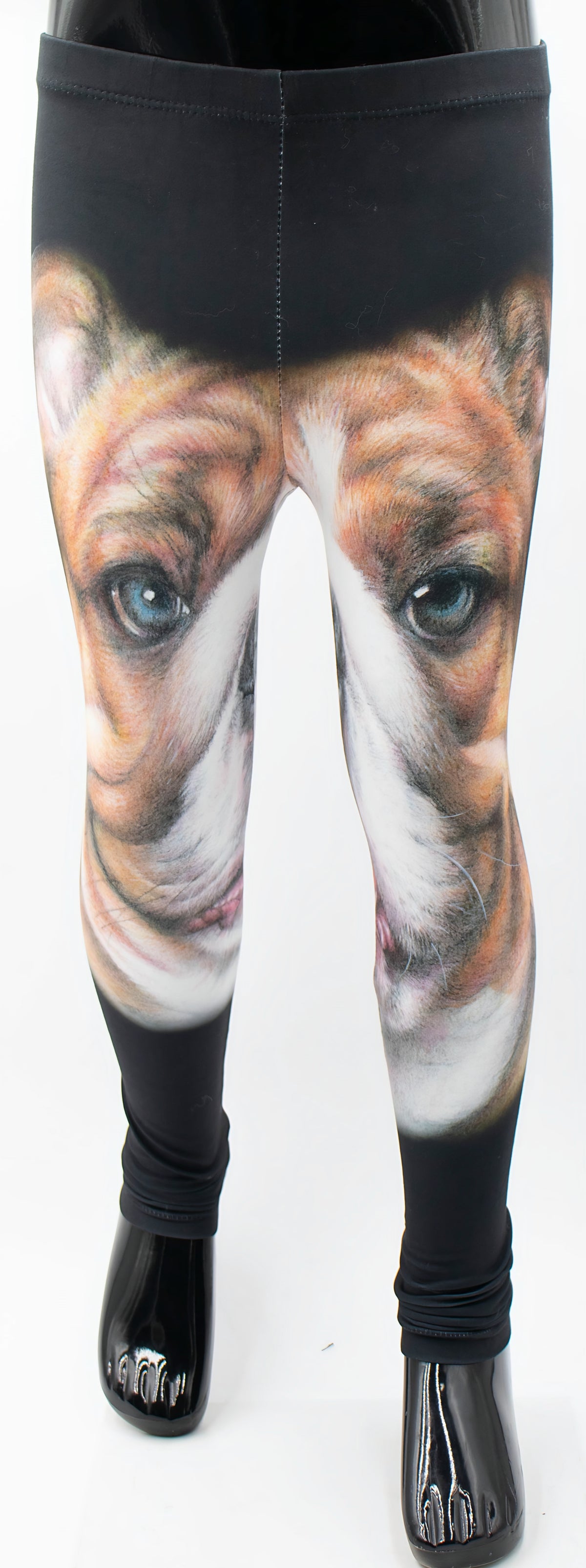 Front view of kids playful bulldog print leggings with a large bulldog face and blue eyes spanning the legs on black fabric.