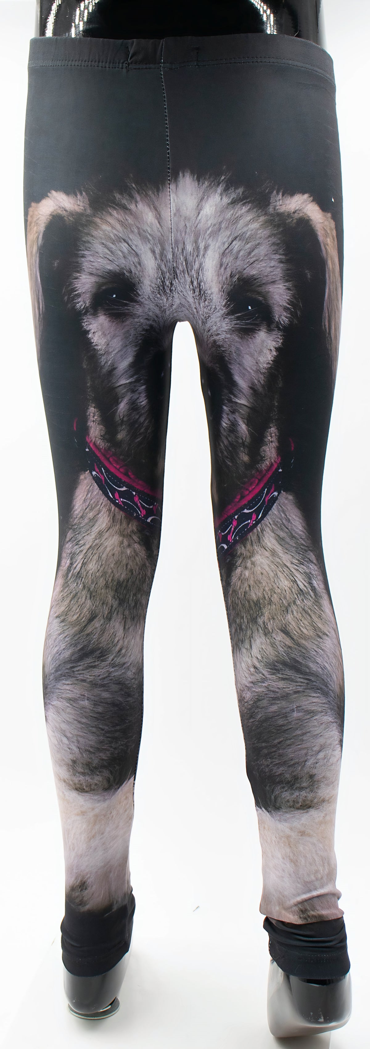Back view of kids Irish Wolfhound print leggings on a mannequin, shaggy wolfhound face with pink patterned collar printed on black fabric.