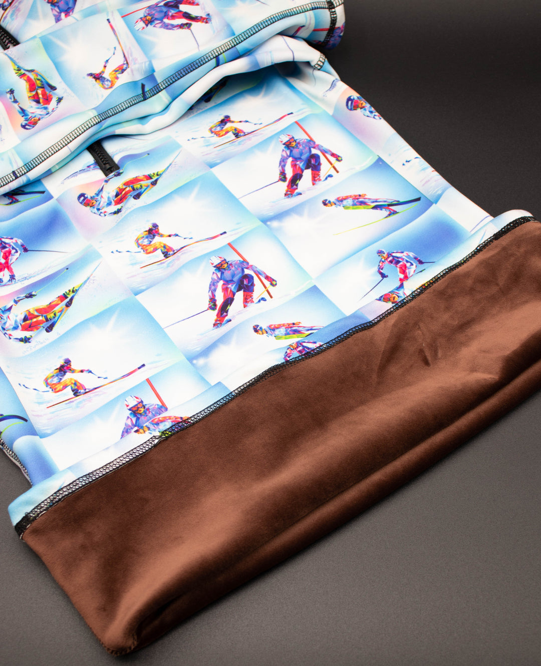 Close-up of skier artwork on Denimaxx mid layer showing rich color and velvety finish.

