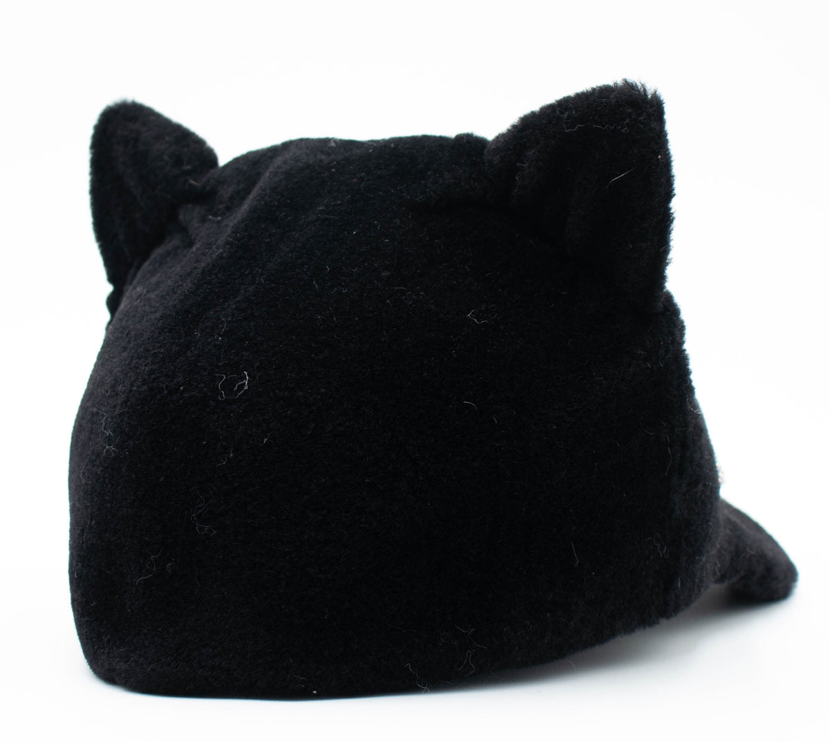 Back view of the black faux fur cat ear cap showing the plush ears on a white background.
