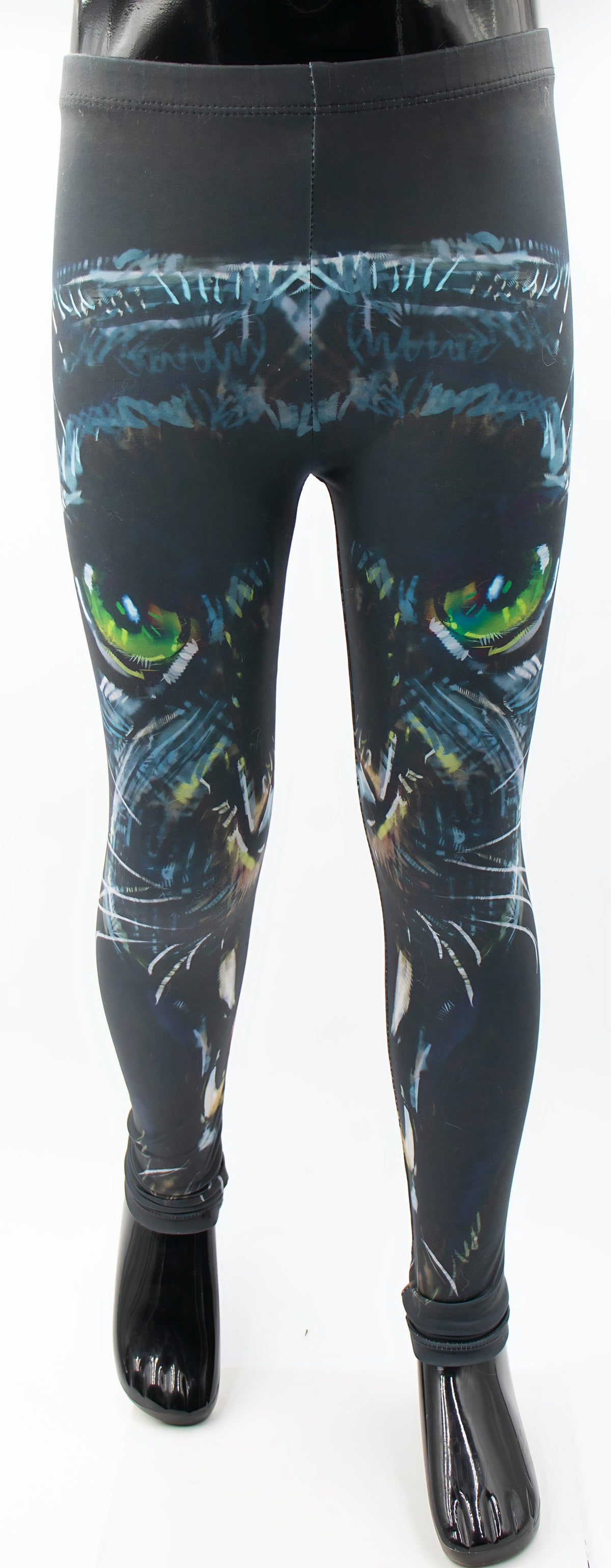 Kids panther print leggings with a large black panther face and glowing green eyes on dark fabric, mannequin display.