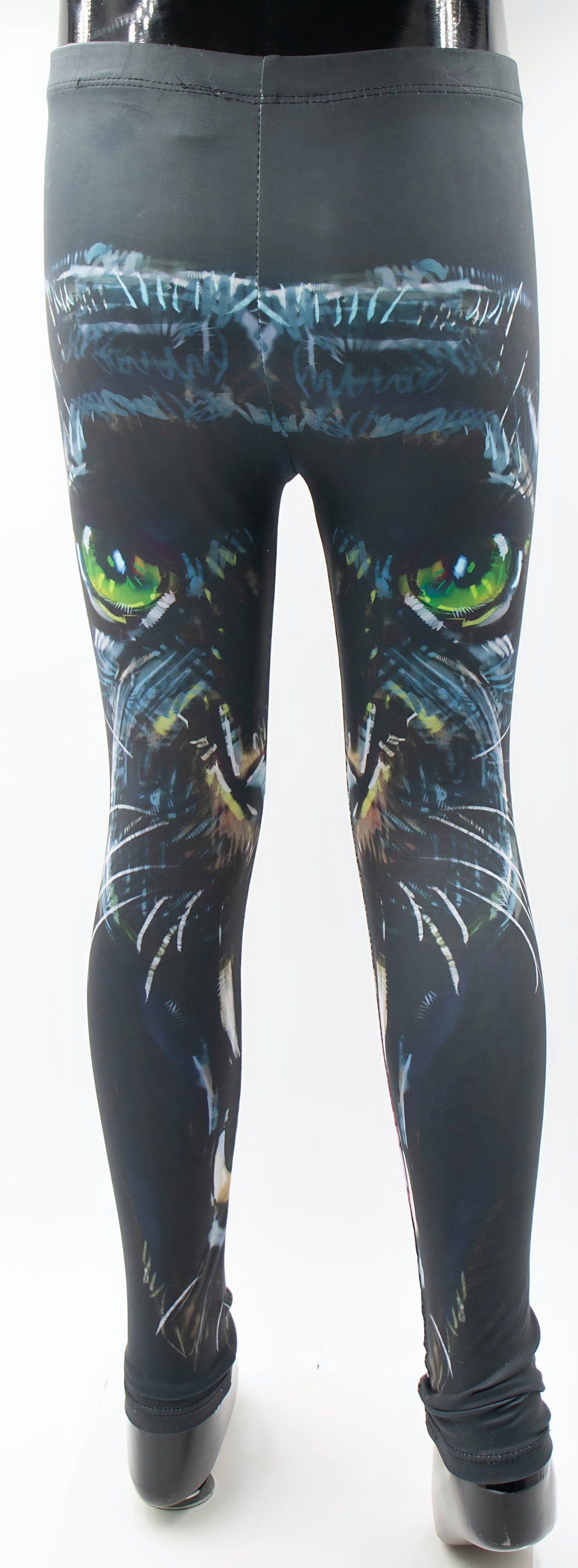 Back view of the kids panther print leggings showing the black panther face with green eyes, mannequin display.