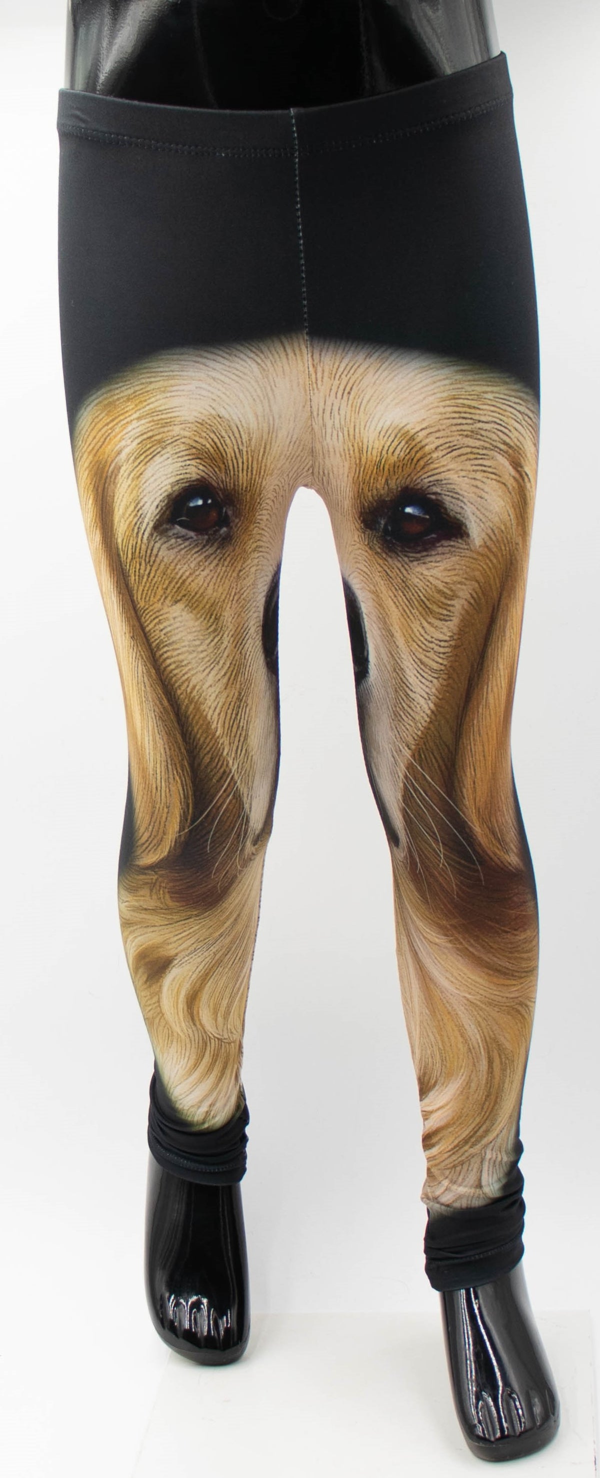 Close-up of kids Golden Retriever puppy print leggings showing the detailed golden face portrait, mannequin display.
