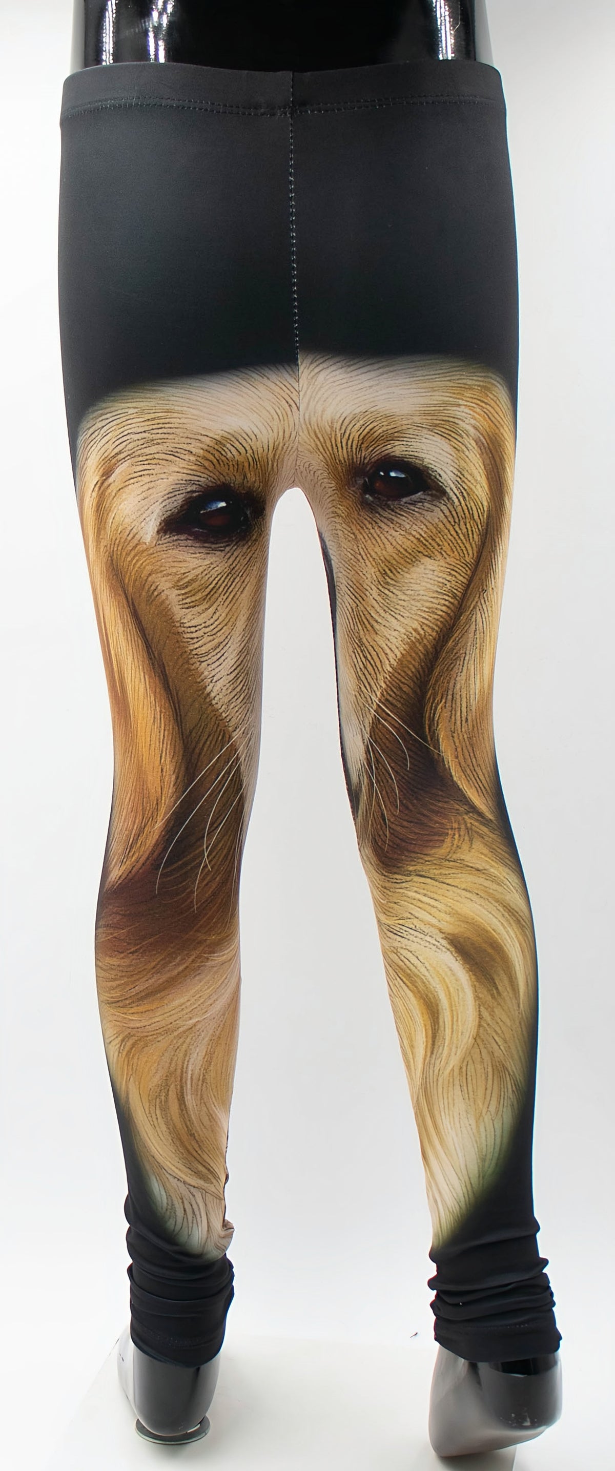 Kids Golden Retriever puppy print leggings with a large golden face portrait across the legs, shown on a mannequin.