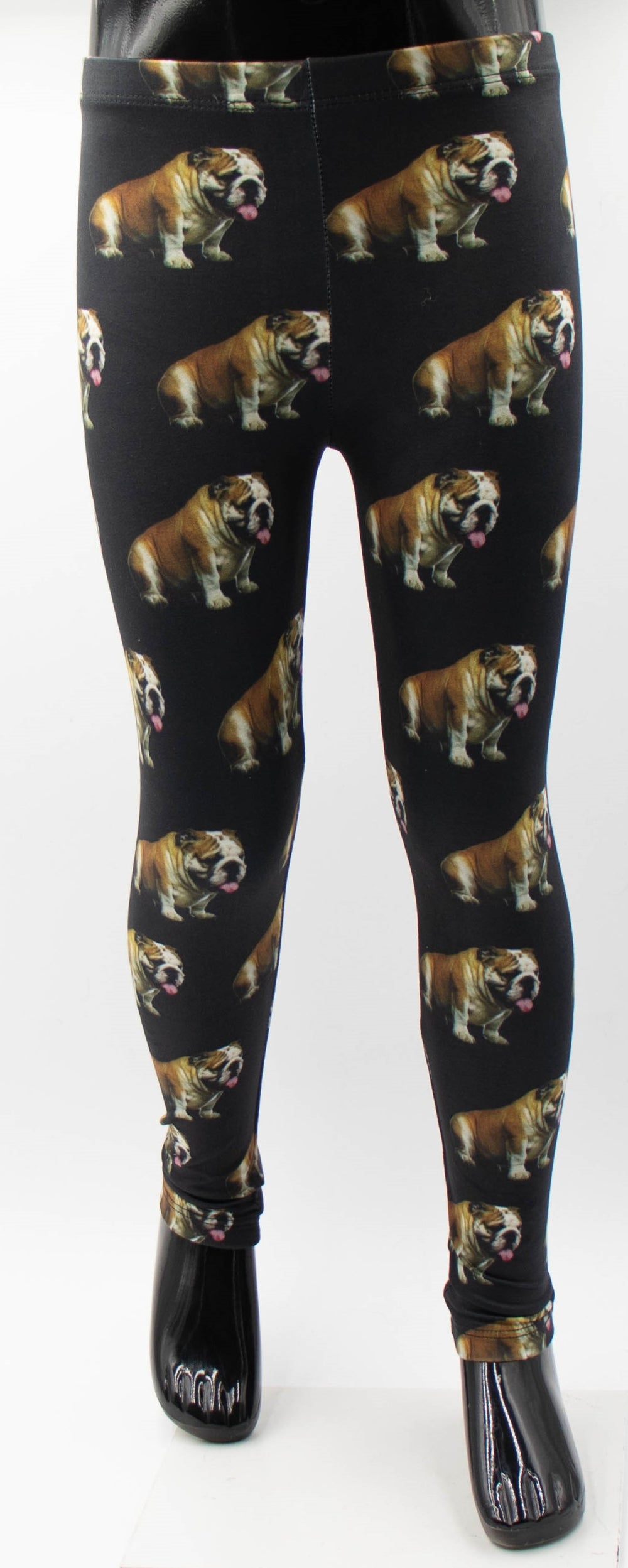 Front view of Denimaxx kids bulldog print leggings with an all-over pattern of small bulldogs with tongues out on black fabric.