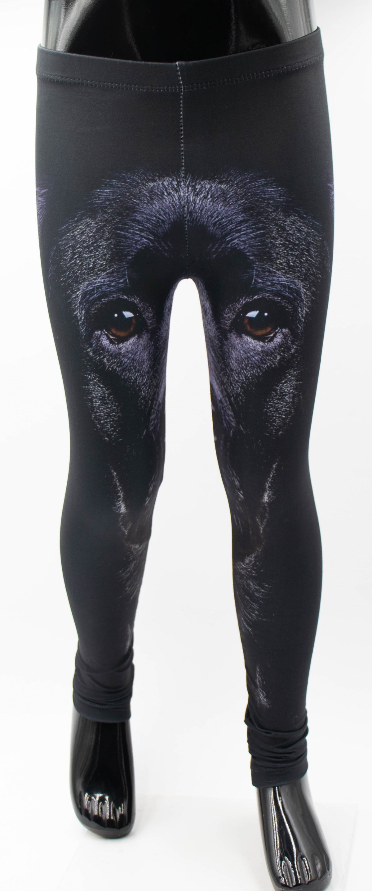 Back view of kids Labrador print leggings with a large black labrador face print on black, studio product shot.