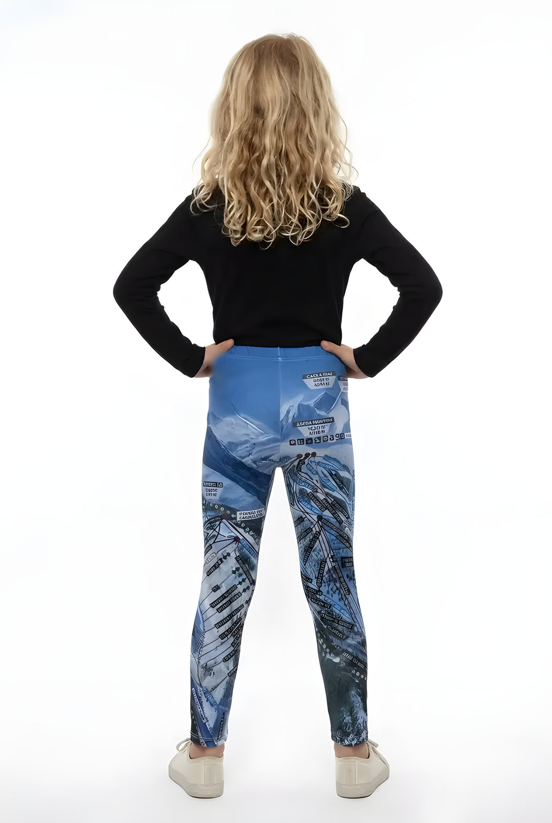 Back view of a girl in a black long-sleeve top wearing blue Aspen Trail Map ski map print girls leggings