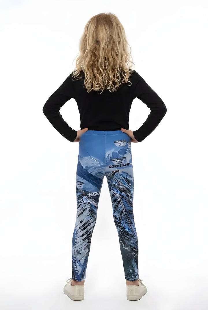 Back view of a girl in a black long-sleeve top wearing blue Aspen Trail Map ski map print girls leggings