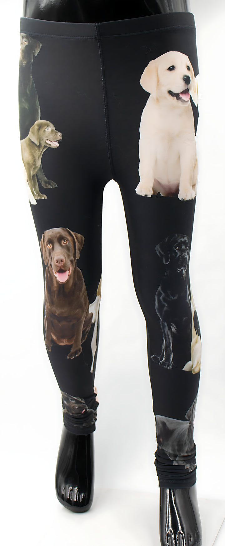 Close-up of kids black Labrador print leggings showing yellow, chocolate, and black Labrador artwork on the legs.