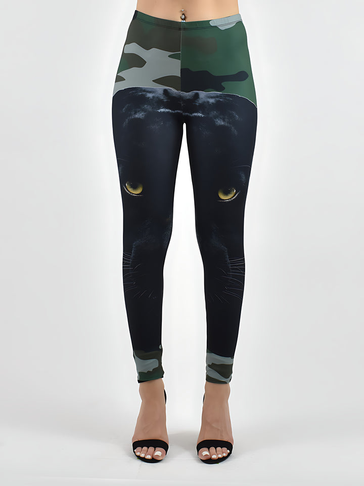Close-up of camo panther print leggings showing the black panther face with yellow eyes, green camo waistband and ankle cuffs.