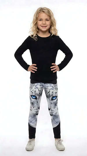 Girl in a black long-sleeve top wearing girls leggings with a blue-eyed white snow leopard face on the upper legs