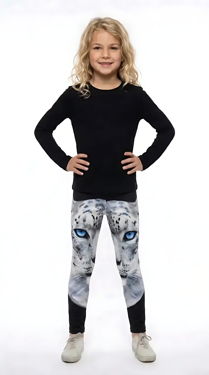 Girl in a black long-sleeve top wearing girls leggings with a blue-eyed white snow leopard face on the upper legs