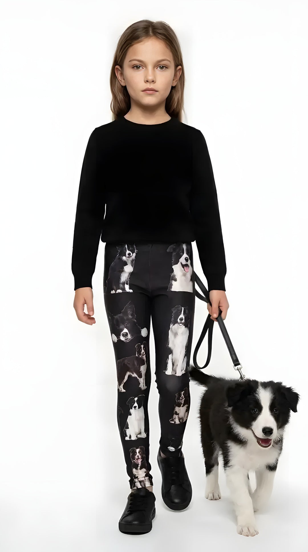 Girl in a black sweater walking a black-and-white border collie puppy, wearing border collie print girls leggings