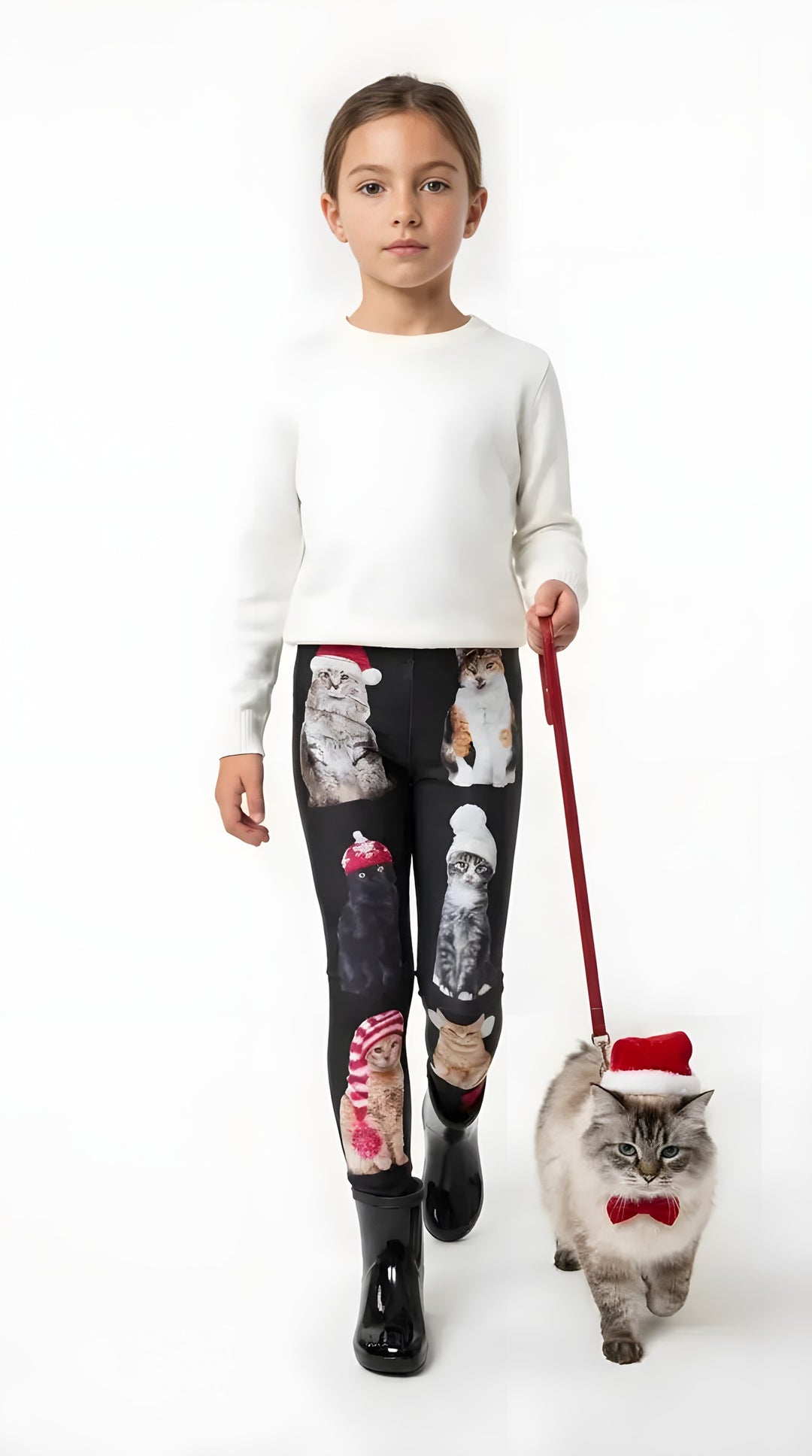 Girl wearing black Christmas cat print kids leggings with a cat in Santa hat