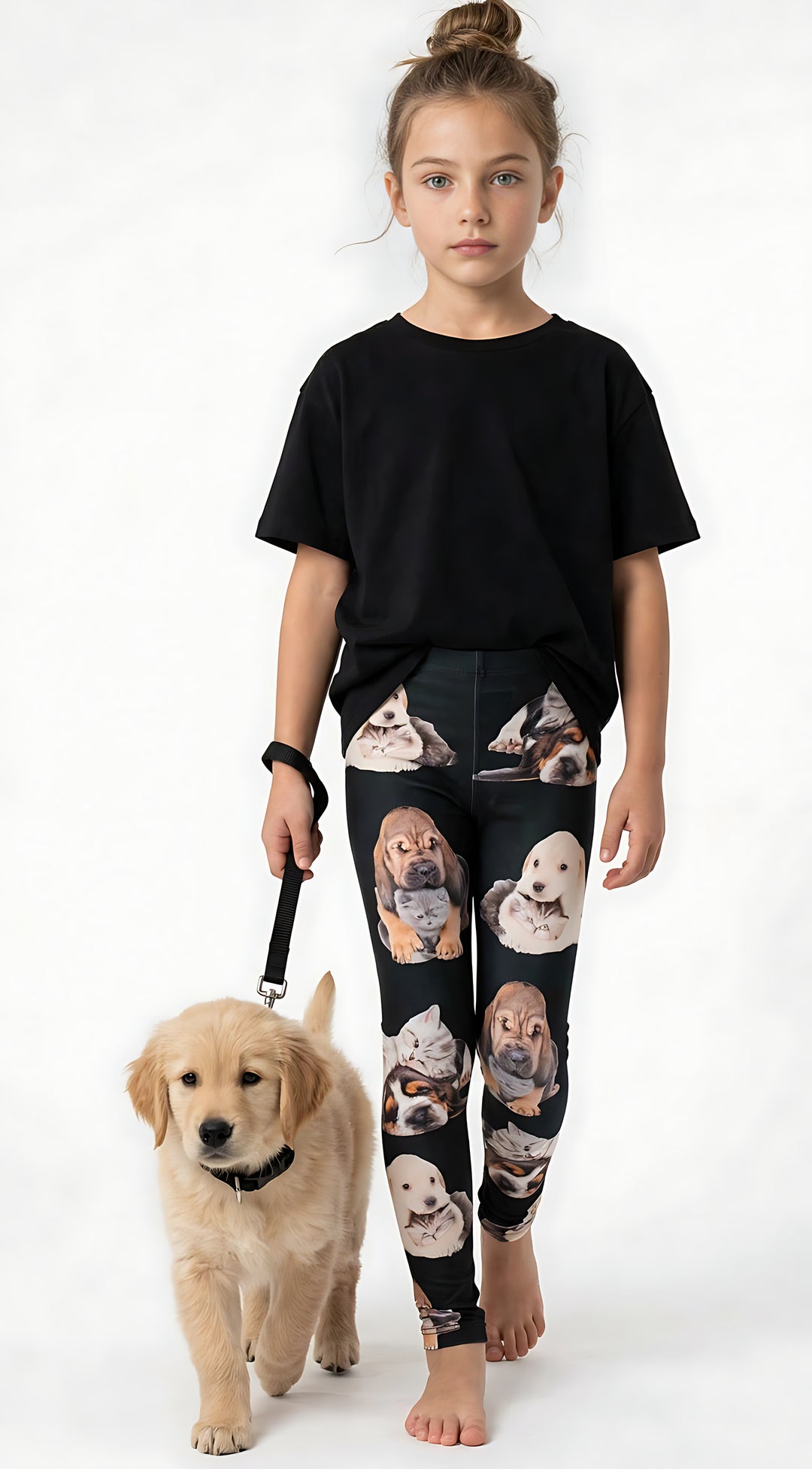 Young girl with a top knot wearing kids kitten and puppy print leggings with cuddling pet artwork, holding a leash with a real golden retriever puppy.