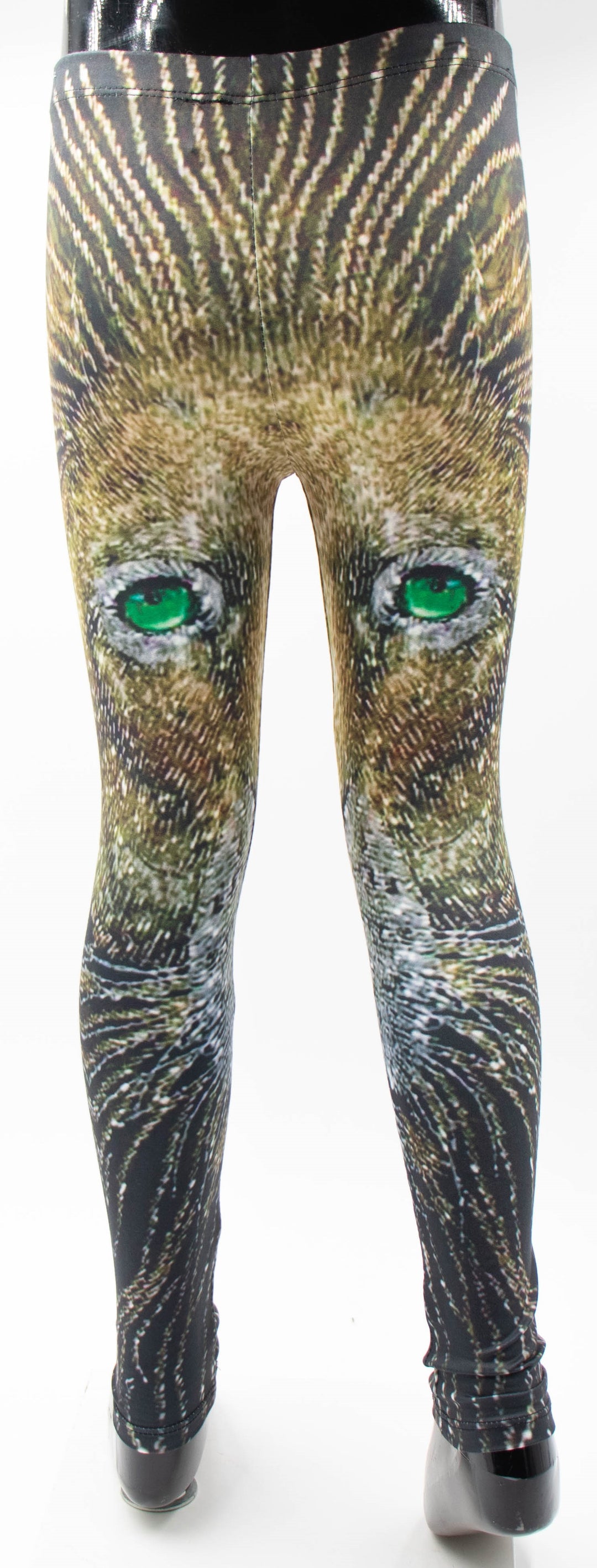 Back view of Denimaxx kids lion print leggings on a mannequin, lion face with vivid green eyes printed in golden brown fur tones.