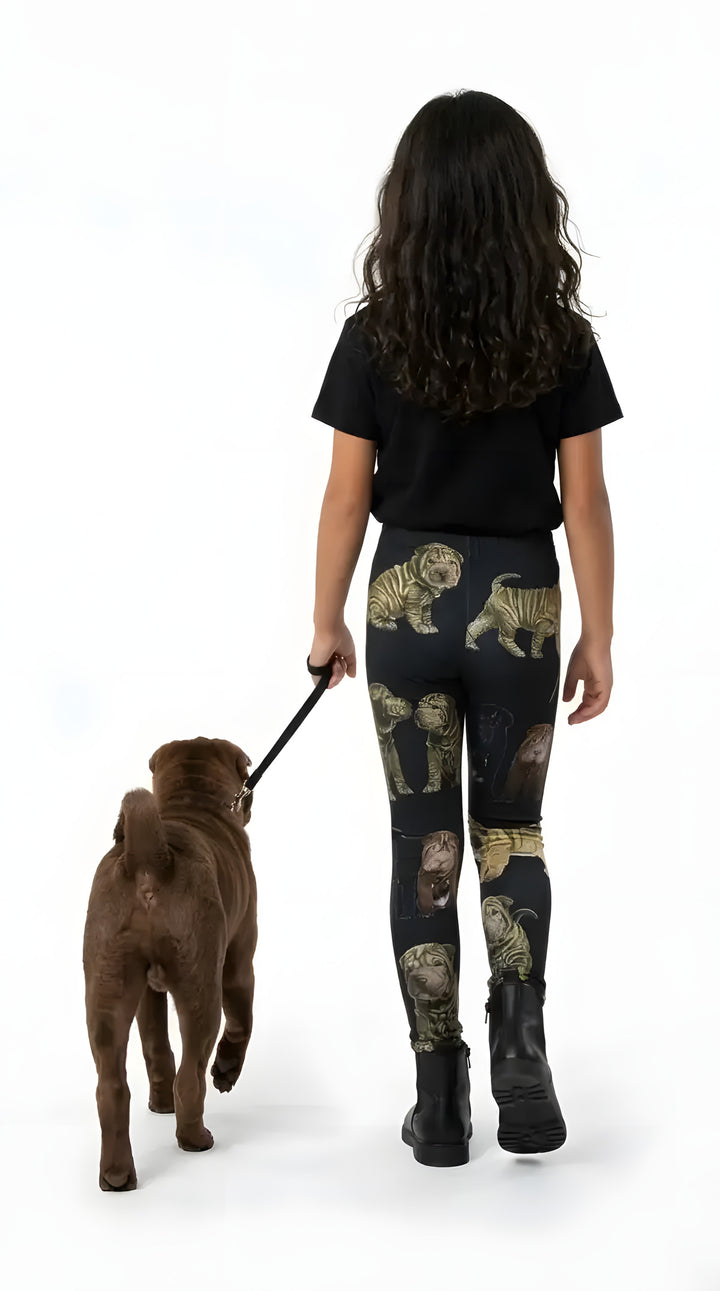 Back view of a girl walking a brown Shar Pei, wearing black Shar Pei puppy print girls leggings