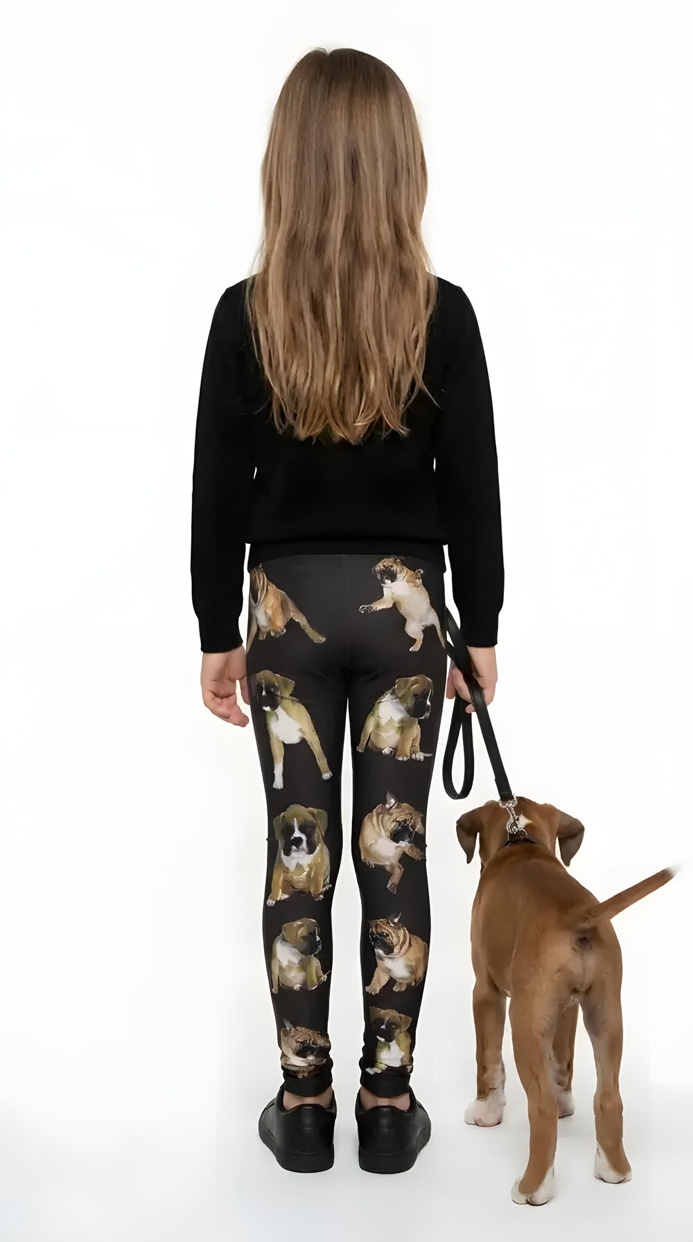 Back view of a girl walking a boxer puppy, wearing black boxer print girls leggings