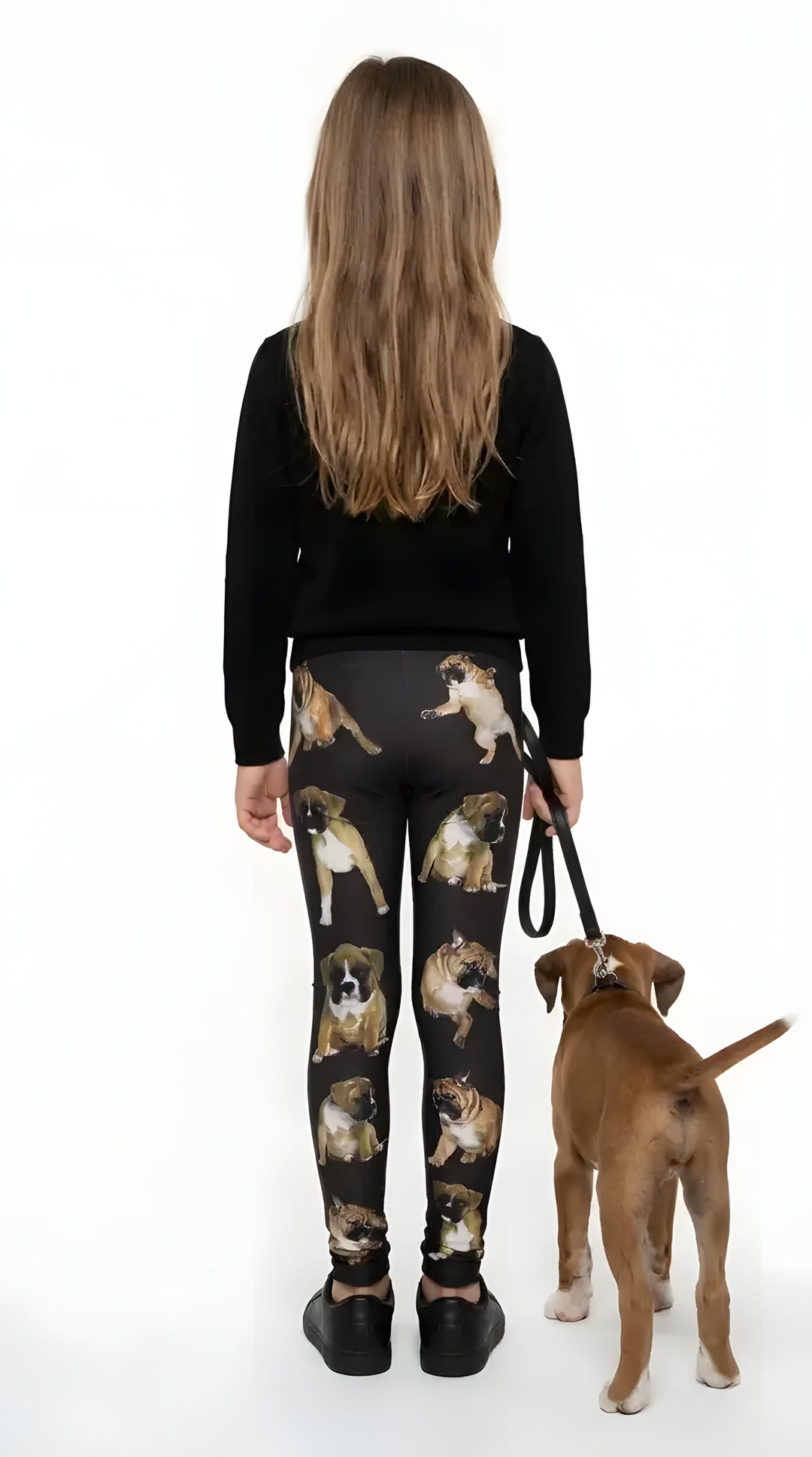 Back view of a girl walking a boxer puppy, wearing black boxer print girls leggings