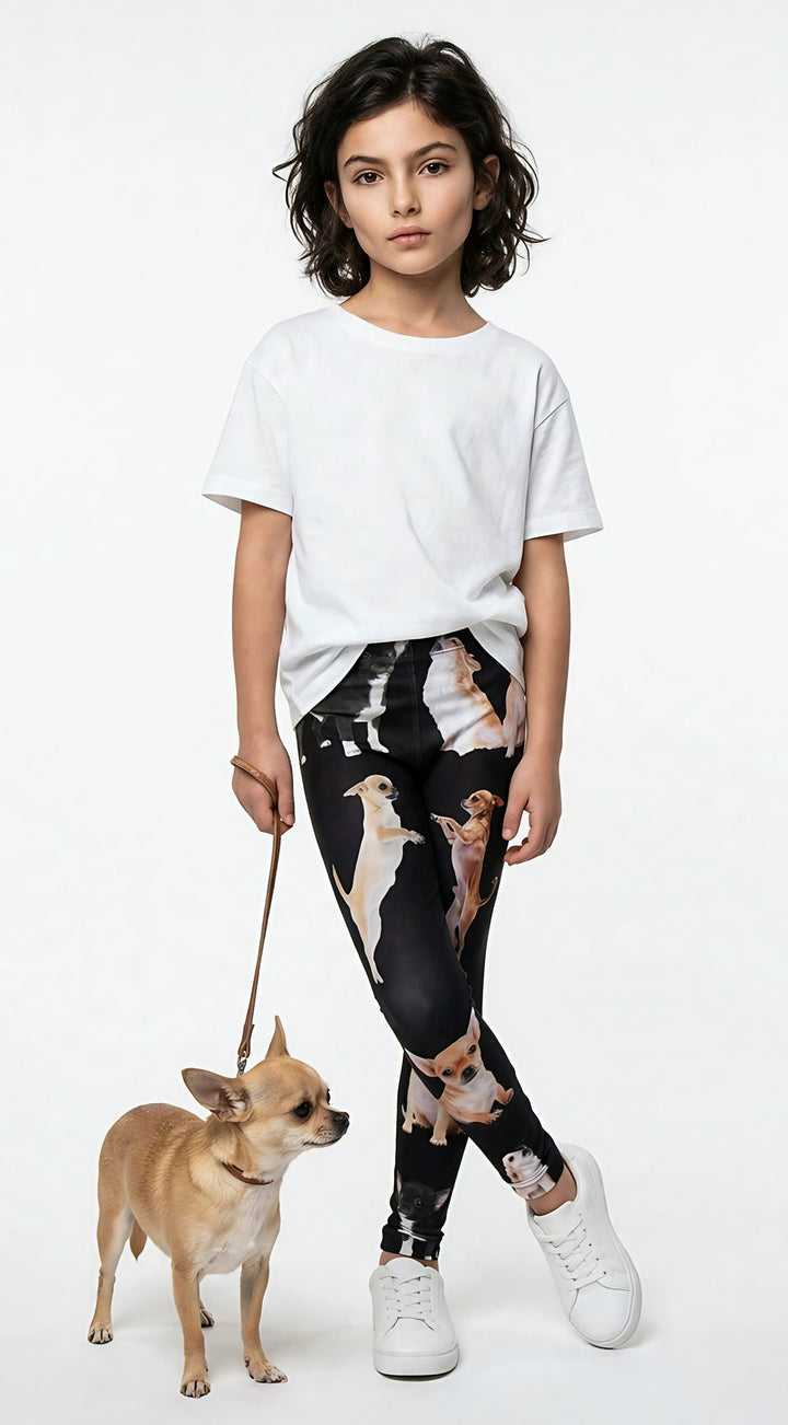 Young girl holding a leash with a real Chihuahua, wearing kids Chihuahua print leggings and a white t-shirt, studio shot.