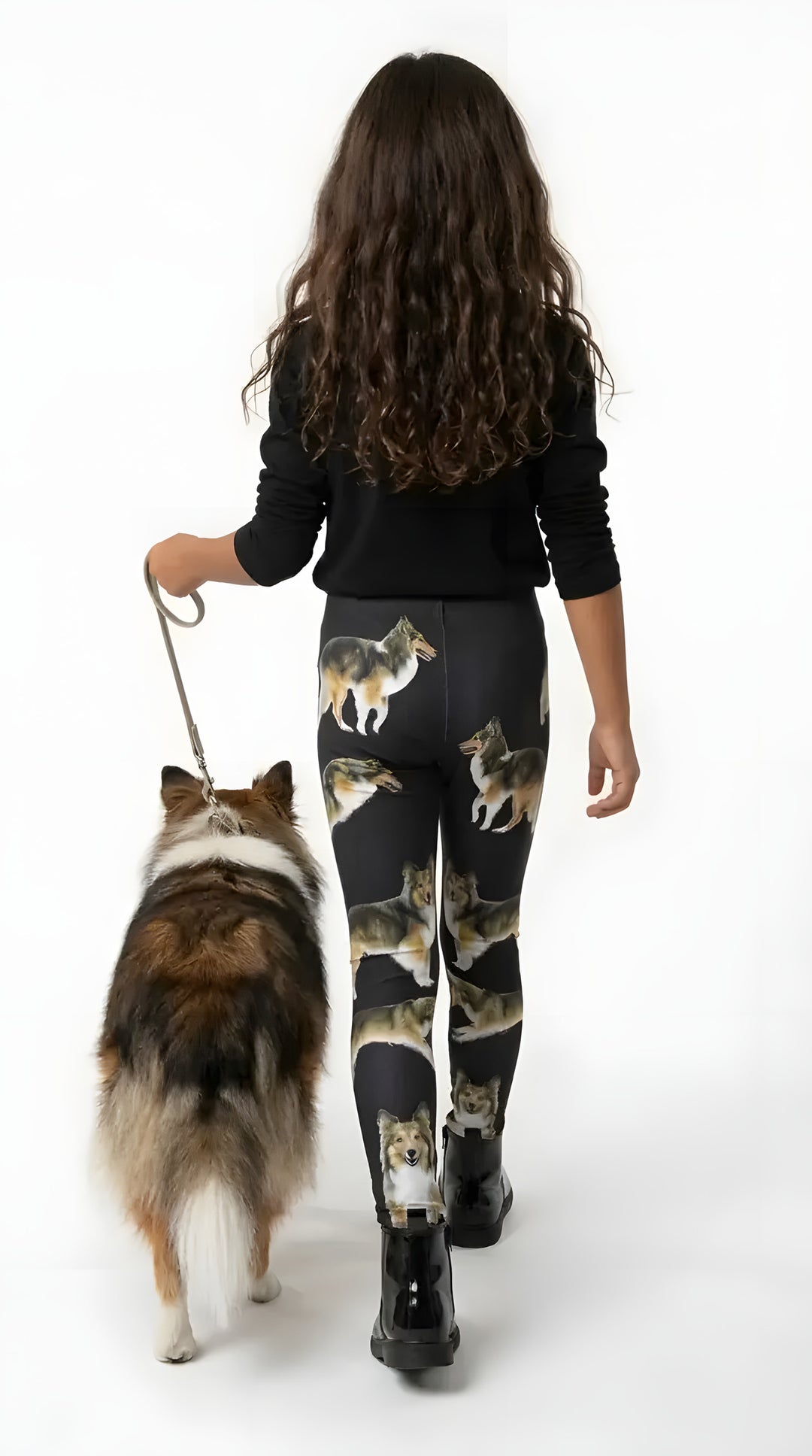 Back view of a girl walking a sable Sheltie, wearing black Sheltie print girls leggings