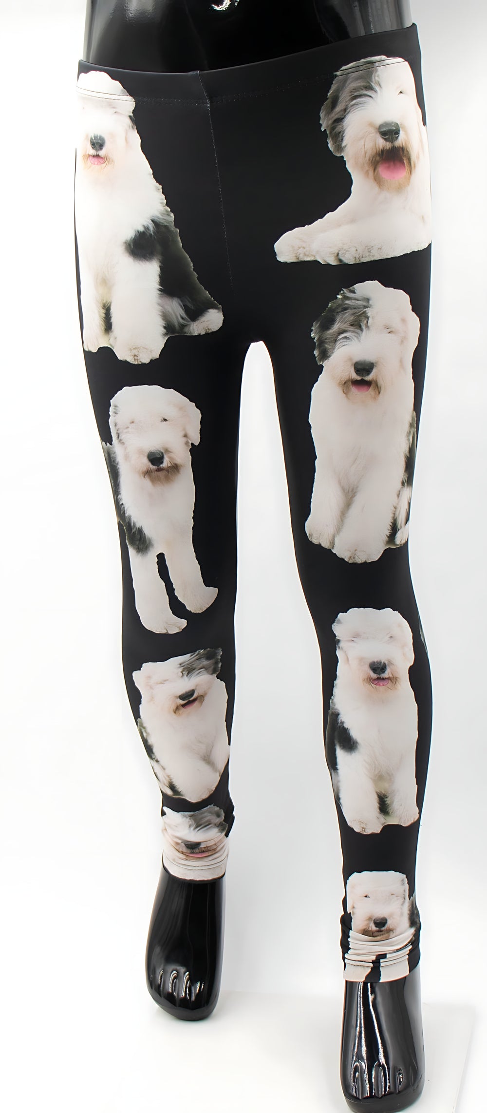 Kids English Sheepdog print leggings with fluffy white and grey sheepdog photos on black fabric, shown on a mannequin.