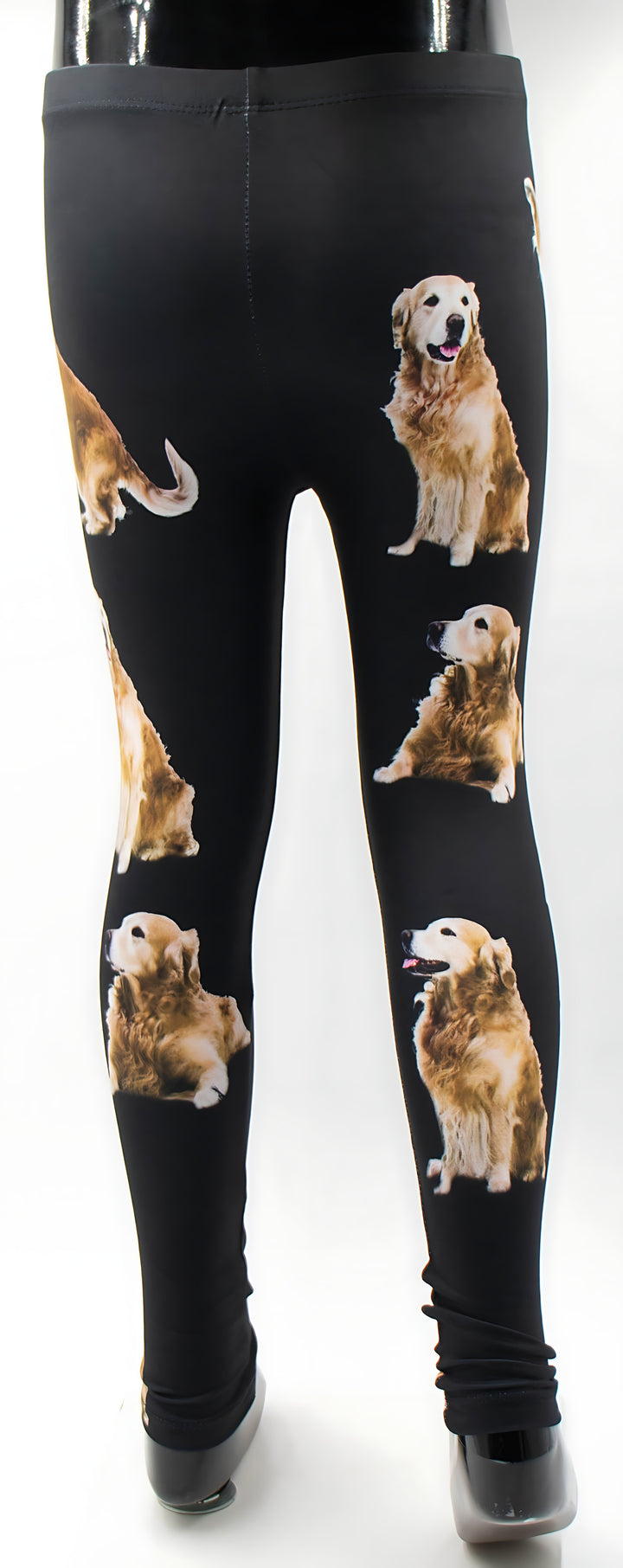 Back view of kids Golden Retriever print leggings with golden retriever photos on black, mannequin display.