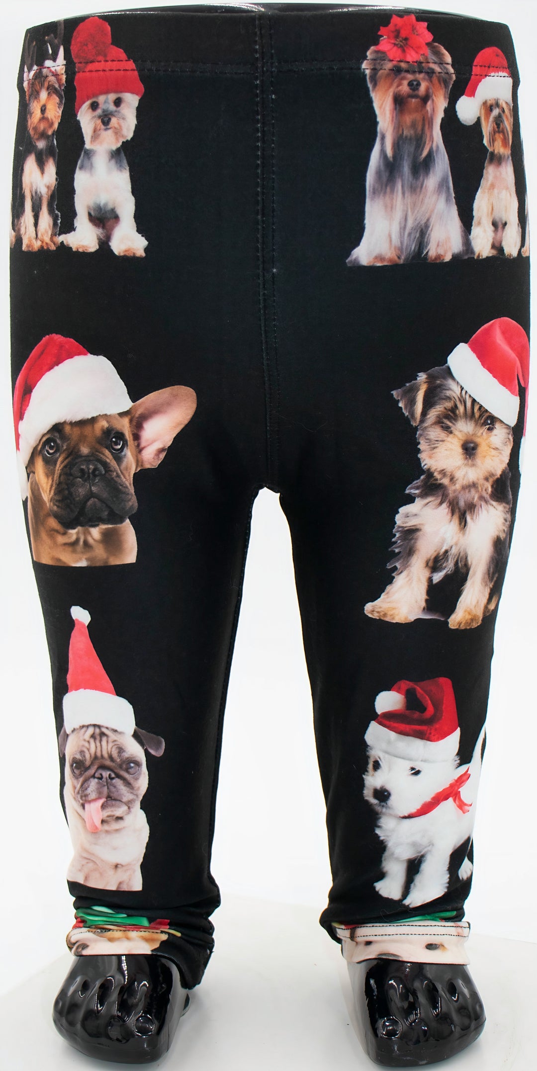 Kids Christmas dogs print leggings with dogs in Santa hats on black fabric, shown on a mannequin.
