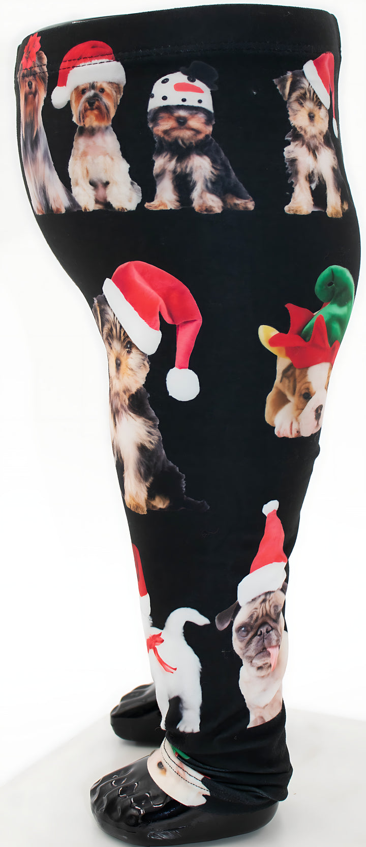 Side view of kids Christmas dogs print leggings showing Yorkies and a Pug in Santa hats, mannequin display.