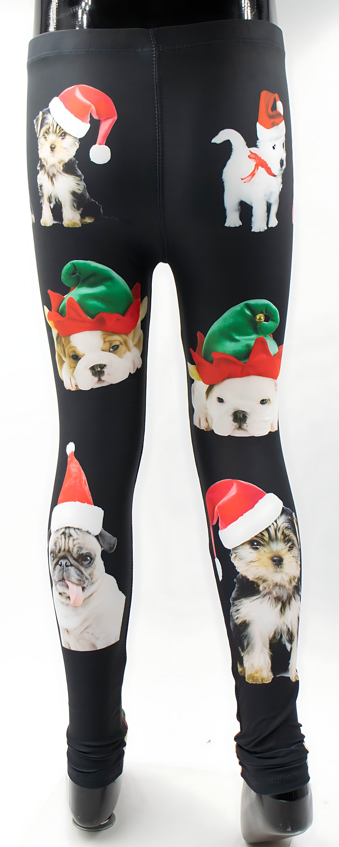 Front view of kids Christmas dogs print leggings with dogs in Santa and elf hats on black, mannequin display.