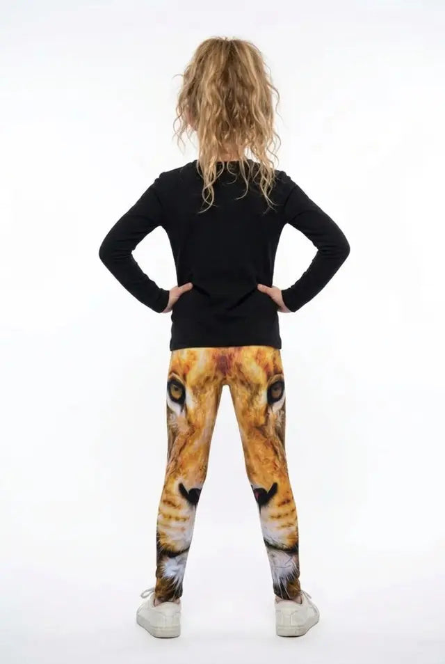 Back view of a girl with curly hair wearing all-over golden lion face print girls leggings