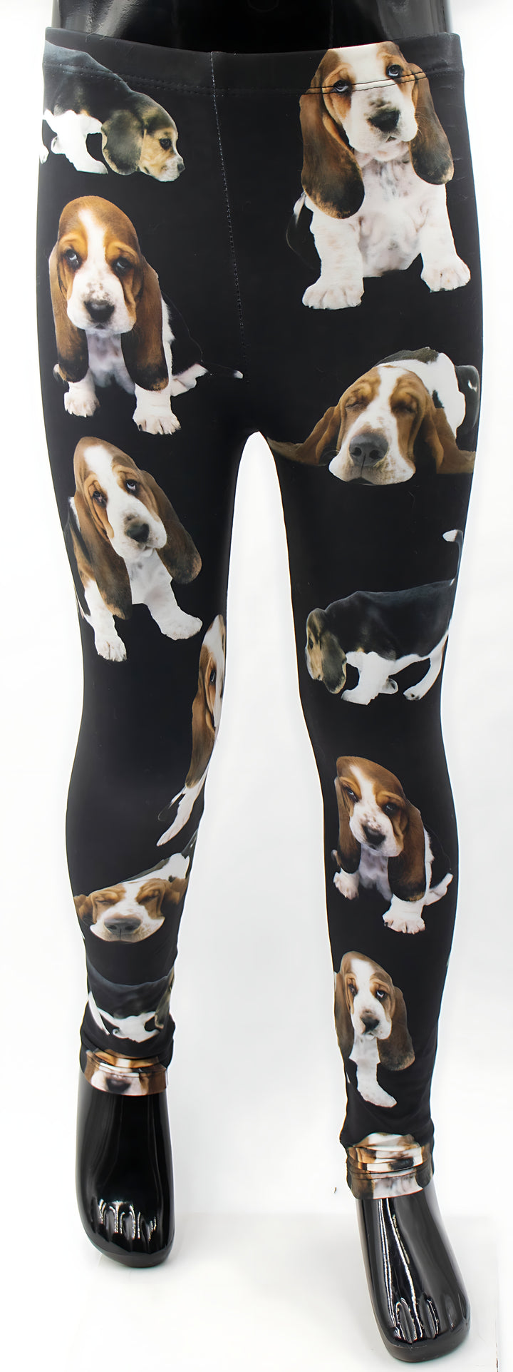 Kids Basset Hound print leggings with Basset Hound puppy prints on black, front view on a child mannequin with black shoes.