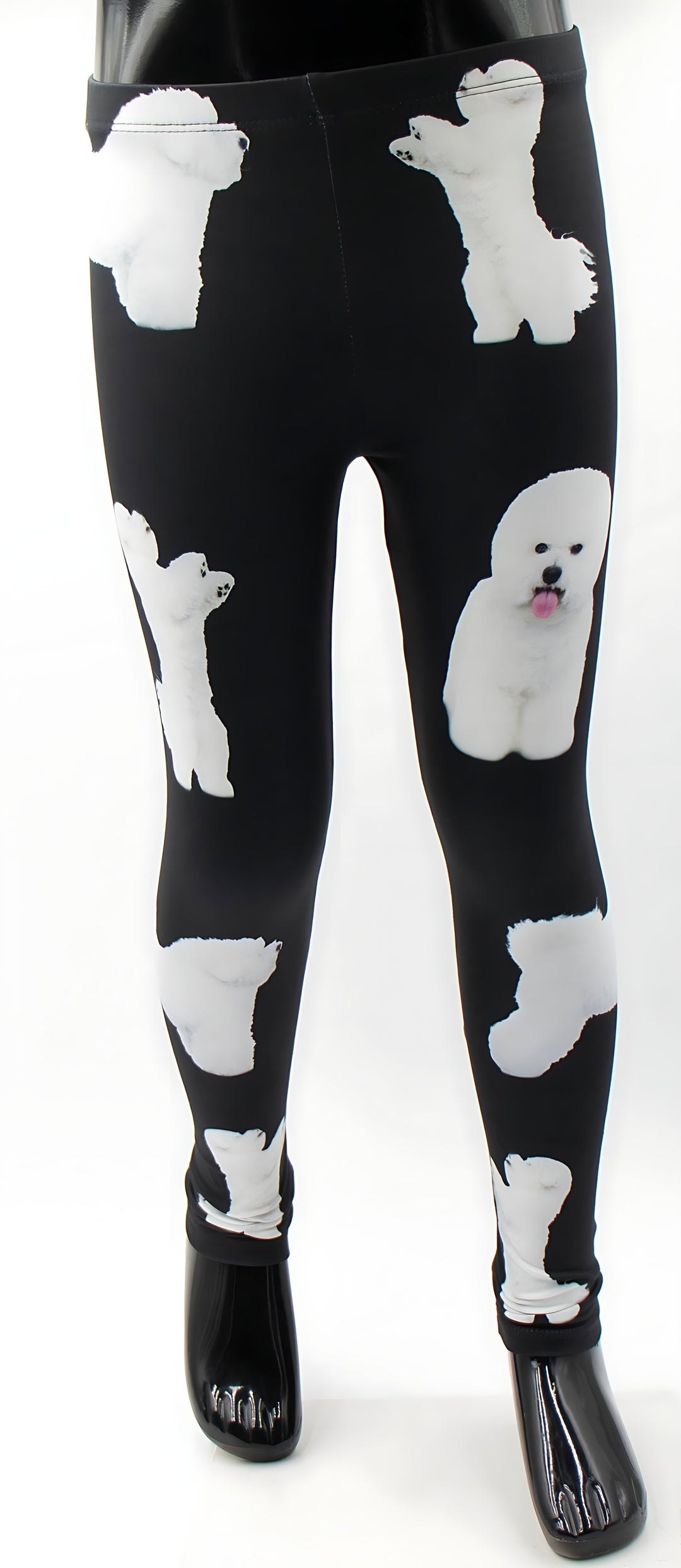 Front view of kids Bichon print leggings with white Bichon Frise dogs on black, shown on a child mannequin.